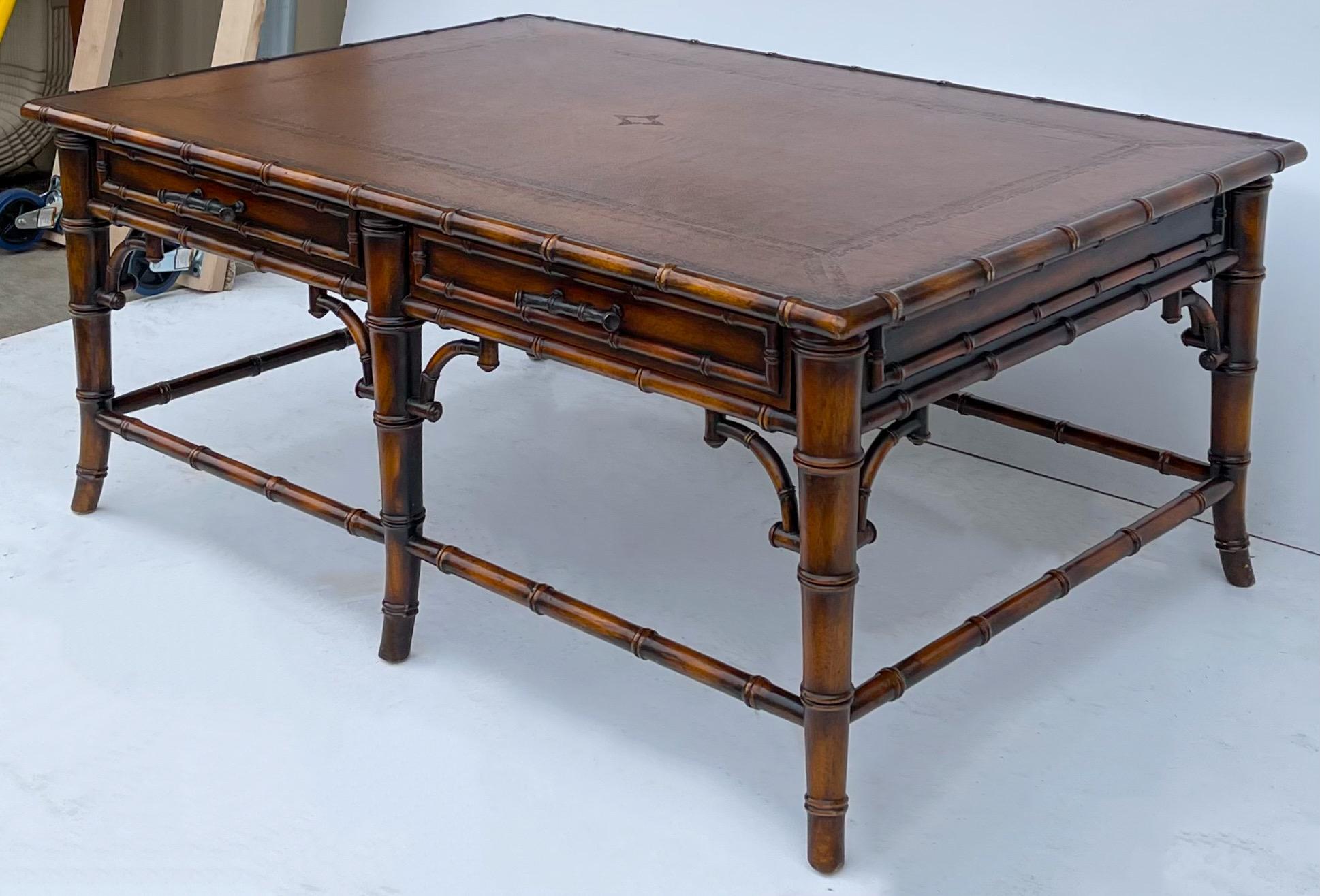 This is a Theodore Alexander Chinese chippendale style faux bamboo coffee table with tooled leather top. One of the sides has functioning drawers, and the other side has faux drawers, but identical in appearance. It is in very good condition.
