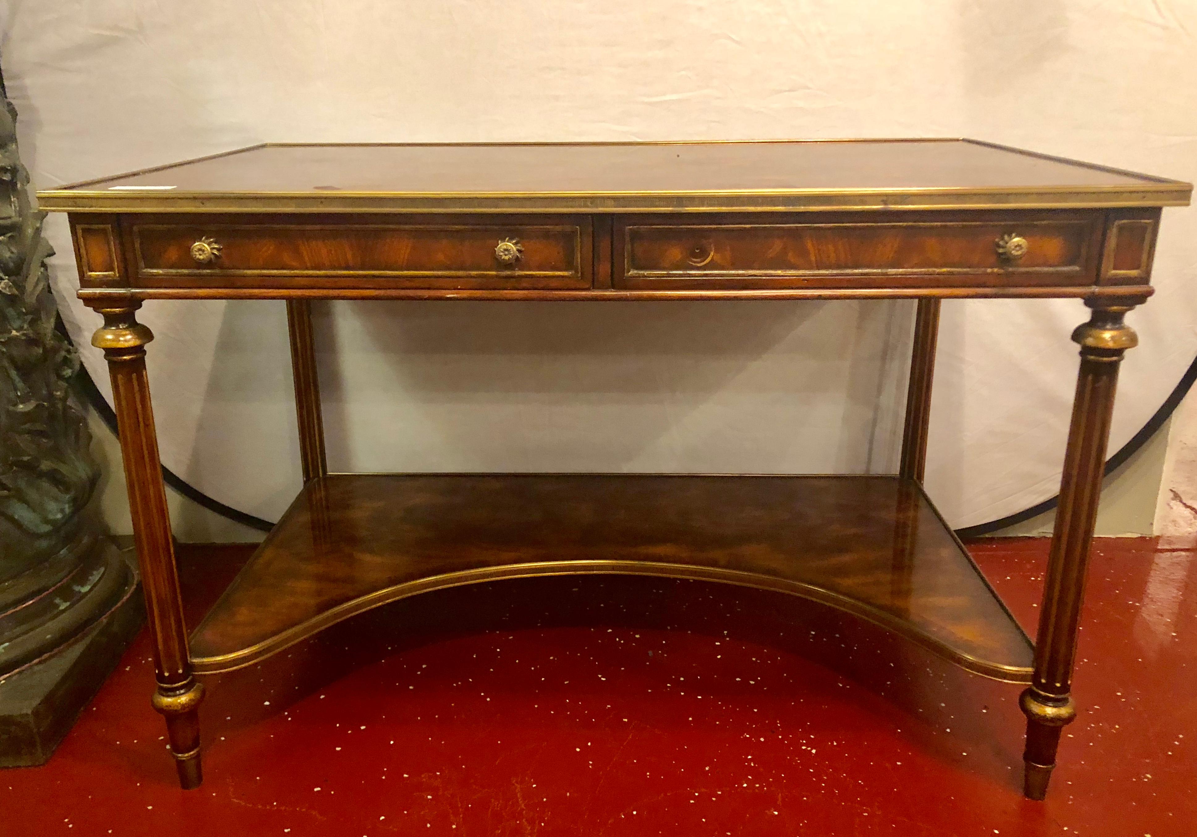 Theodore Alexander desk in the Louis XVI style having a bronze framed flame mahogany top.