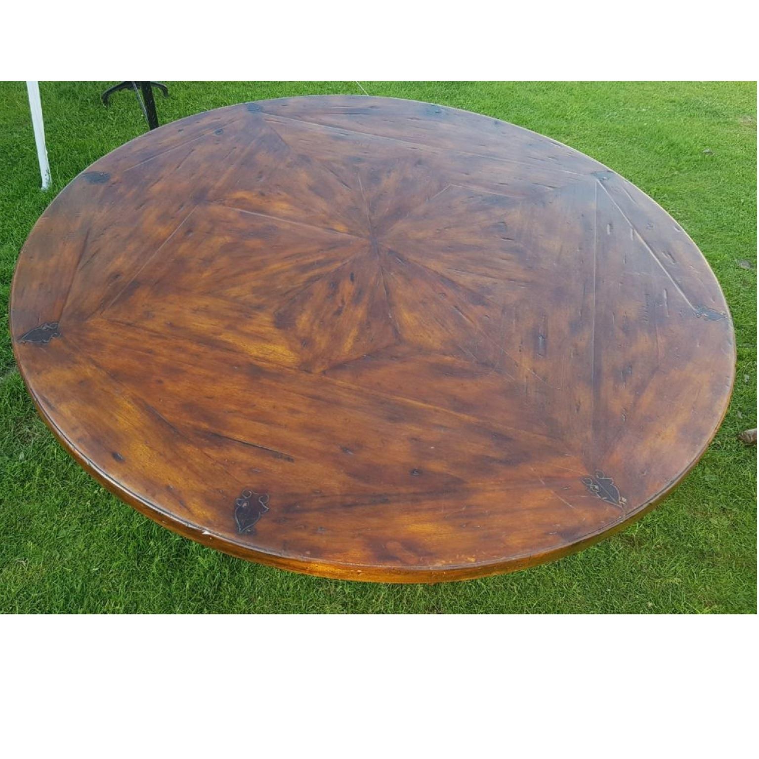 Theodore Alexander dining centre table in the style of a 17th century Stuart table

An antiqued mahogany wood circular dining or kitchen table, the top with stellar parquetry above four baluster turned supports, on and ‘X’ base. In the style of a