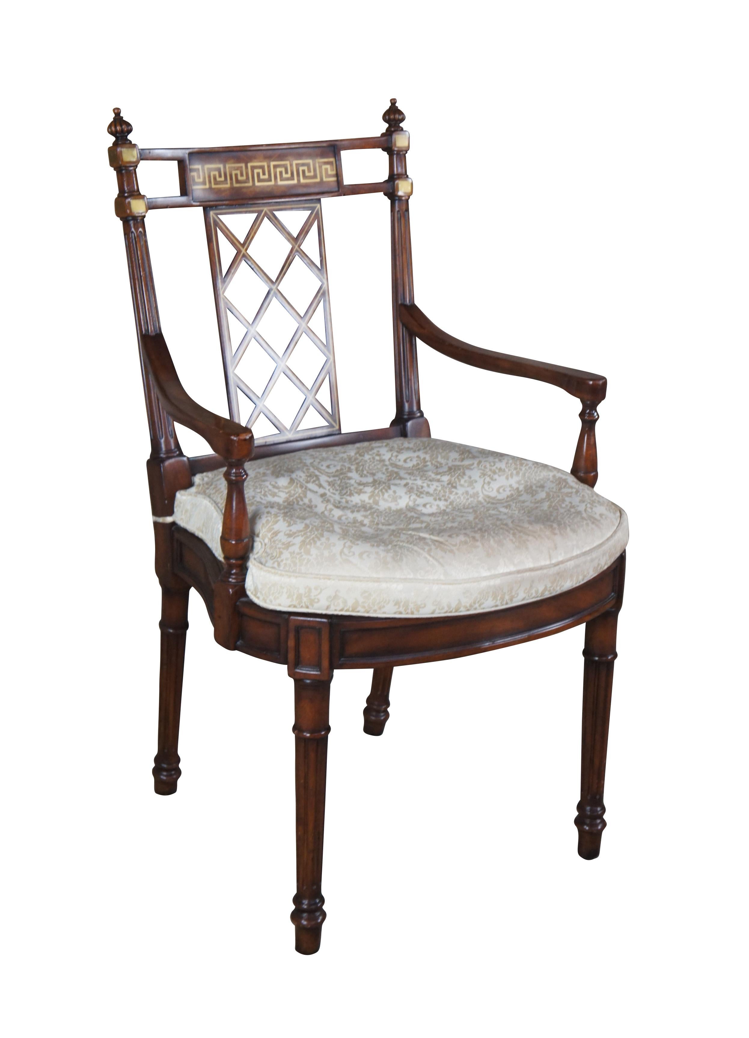 A fine vintage Theodore Alexander flame mahogany armchair featuring a trellis pierced splat back with Greek key brass inlay, caned seat with a cream / gold / tan damask down filled cushion over turned reeded legs. 4100-511

Dimensions:
23