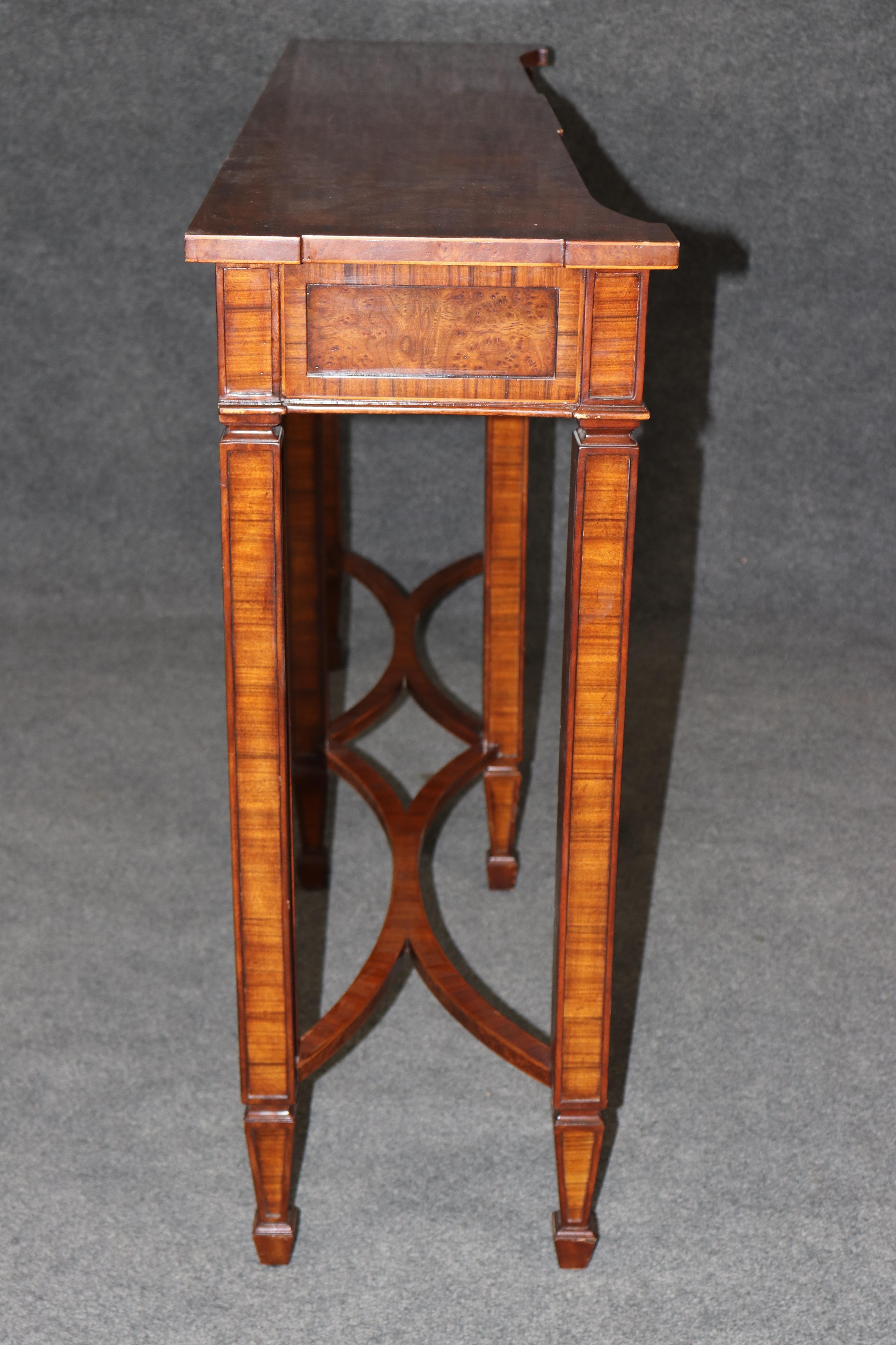 Dimensions - H: 34 1/4 in W: 56 1/4 in D: 13 in

Elevate your space with this elegant Theodore Alexander English style console table, crafted with timeless sophistication and meticulous attention to detail. Featuring a classic rectangular silhouette
