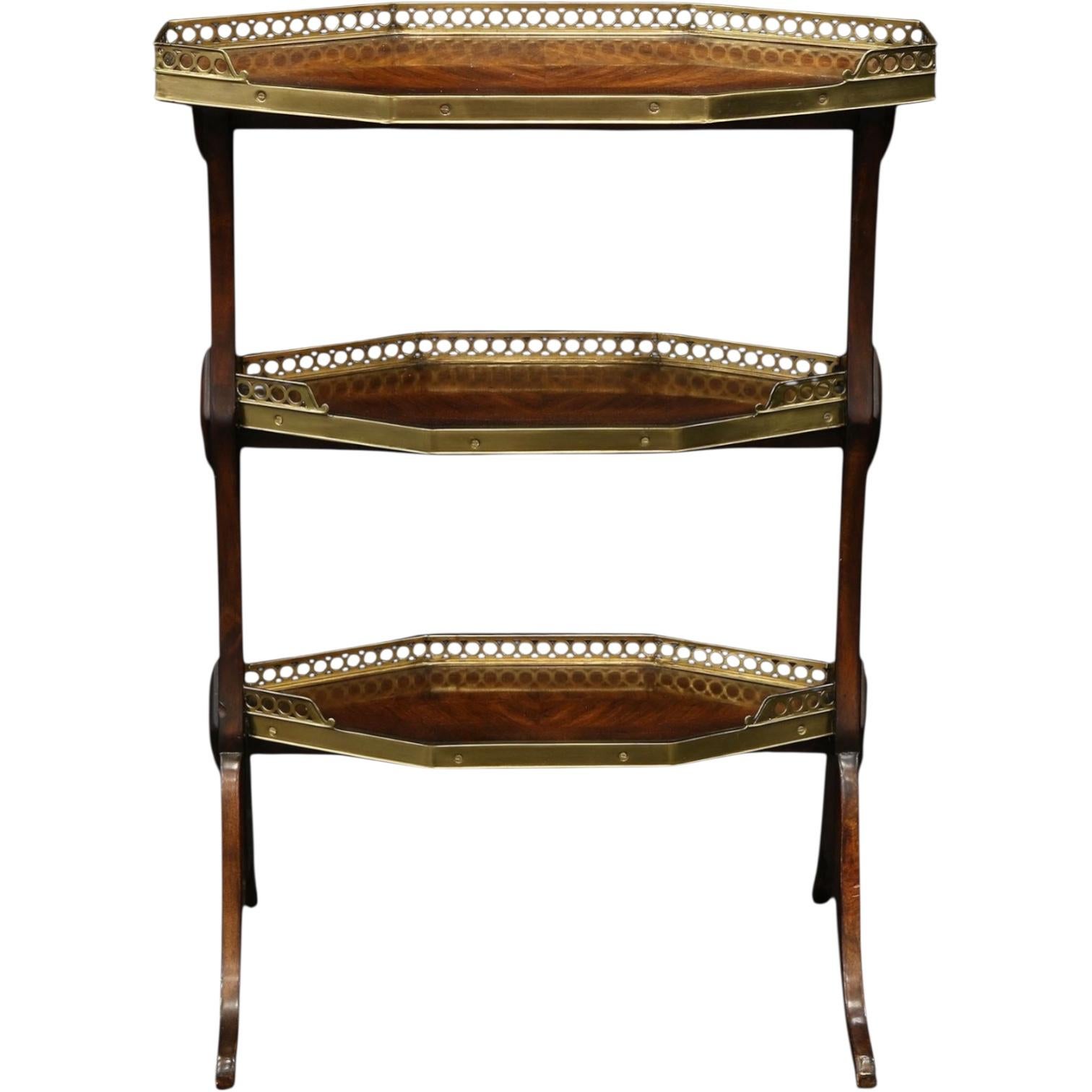 This is a wonderful regency style three tiered butler’s side table designed by Theodore Alexander for Hickory Chair. It appears to be flame mahogany. Each tier has a brass gallery. It is a unique piece and could work from table top to chair side.
