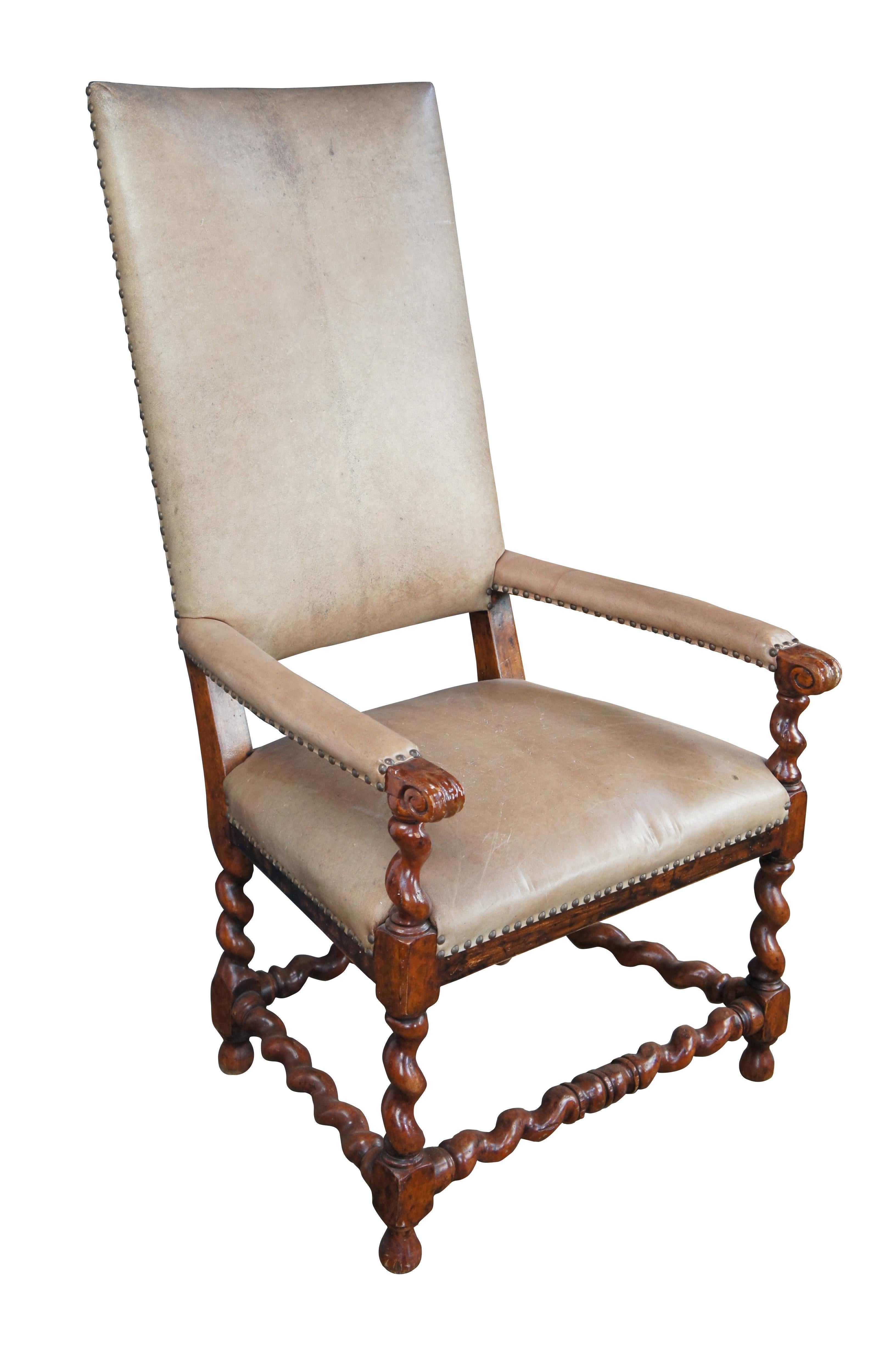 Theodore Alexander Louis XIII style Arm Chair, circa late 20th century. Features a walnut finish with a high leather upholstered back over padded scrolled arms and barley twist supports. Frame is naturally distressed. Includes brass nailhead