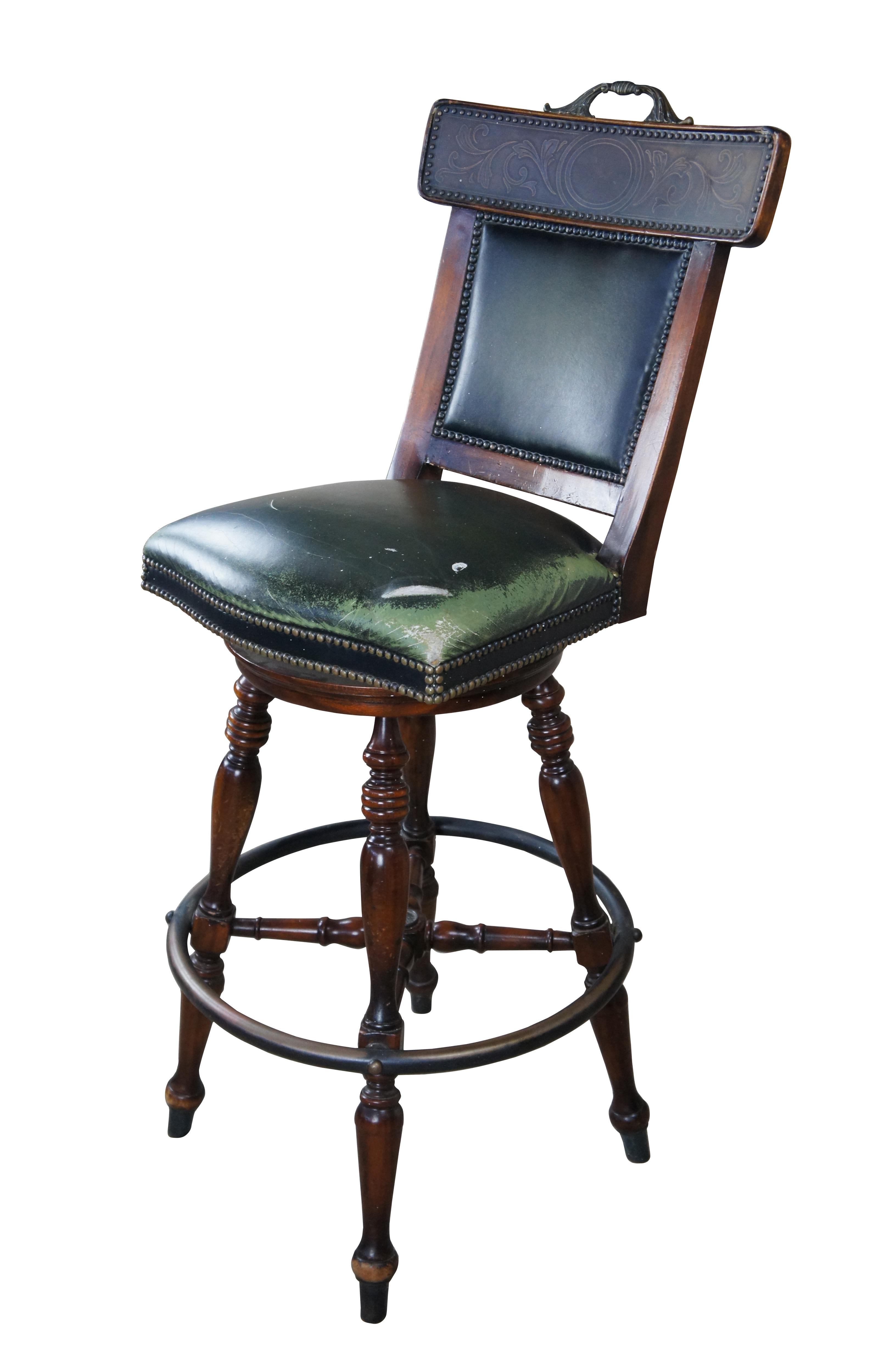 Vintage Theodore Alexander French inspired green leather swivel bar stool.  Features a mahogany frame with embossed brass crest rail over padded back and seat.  Features brass neailhead trim, turned legs and foot rest.  

Dimensions:
21.5