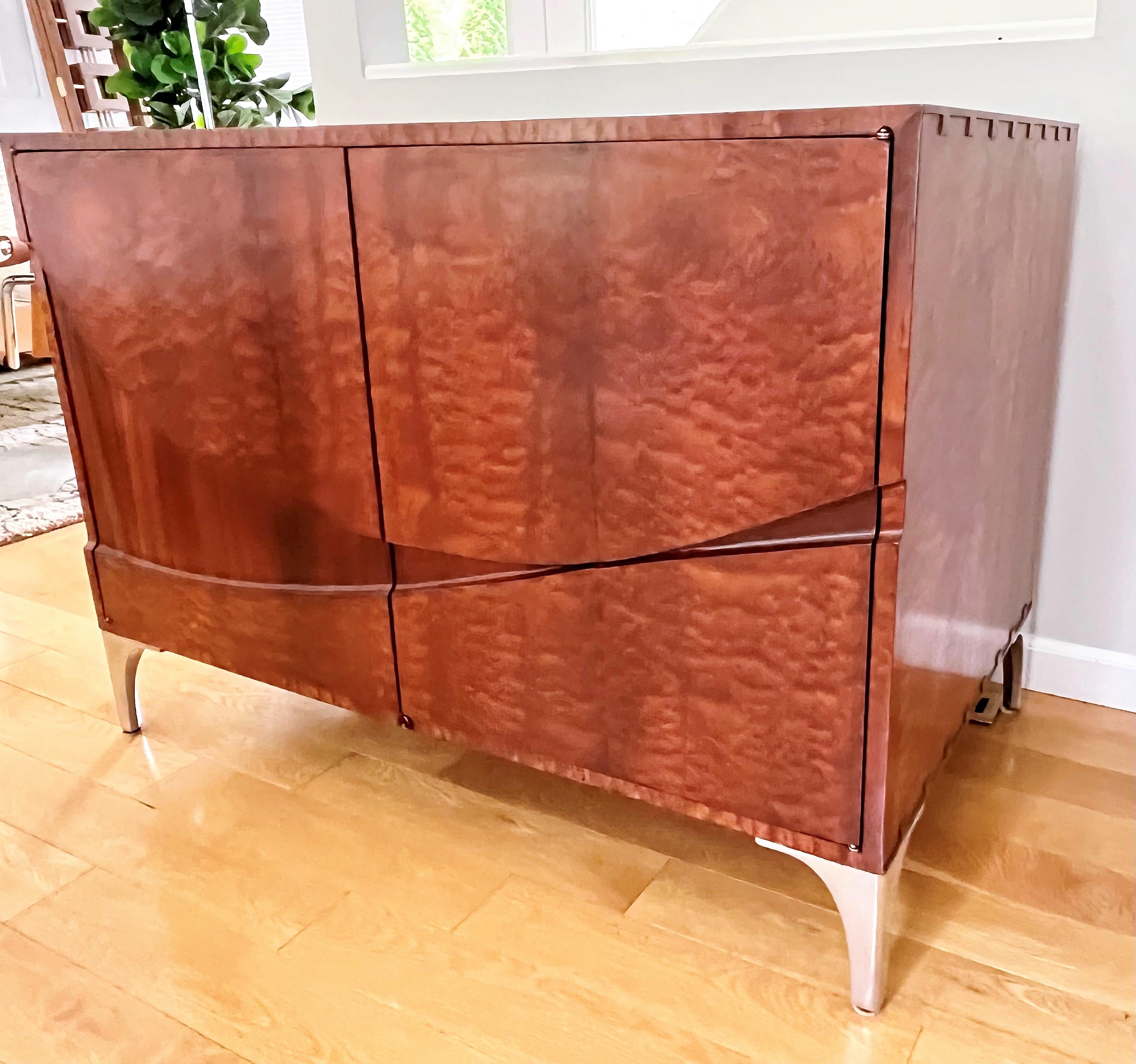 Theodore Alexander Kenos Bros the wave sapele mahogany veneer cabinet with two shelves and three drawers.