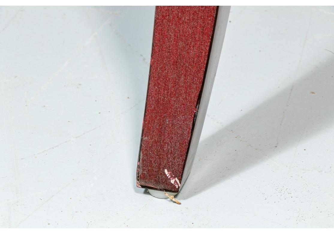 A substantial Theodore Alexander deep relief red Kalahan leather floating drawer on an ebonized wooden base with a chrome/nickel trim and drawer pull. The whole is raised on splayed legs.
Retains price sticker inside drawer as well as Theodore