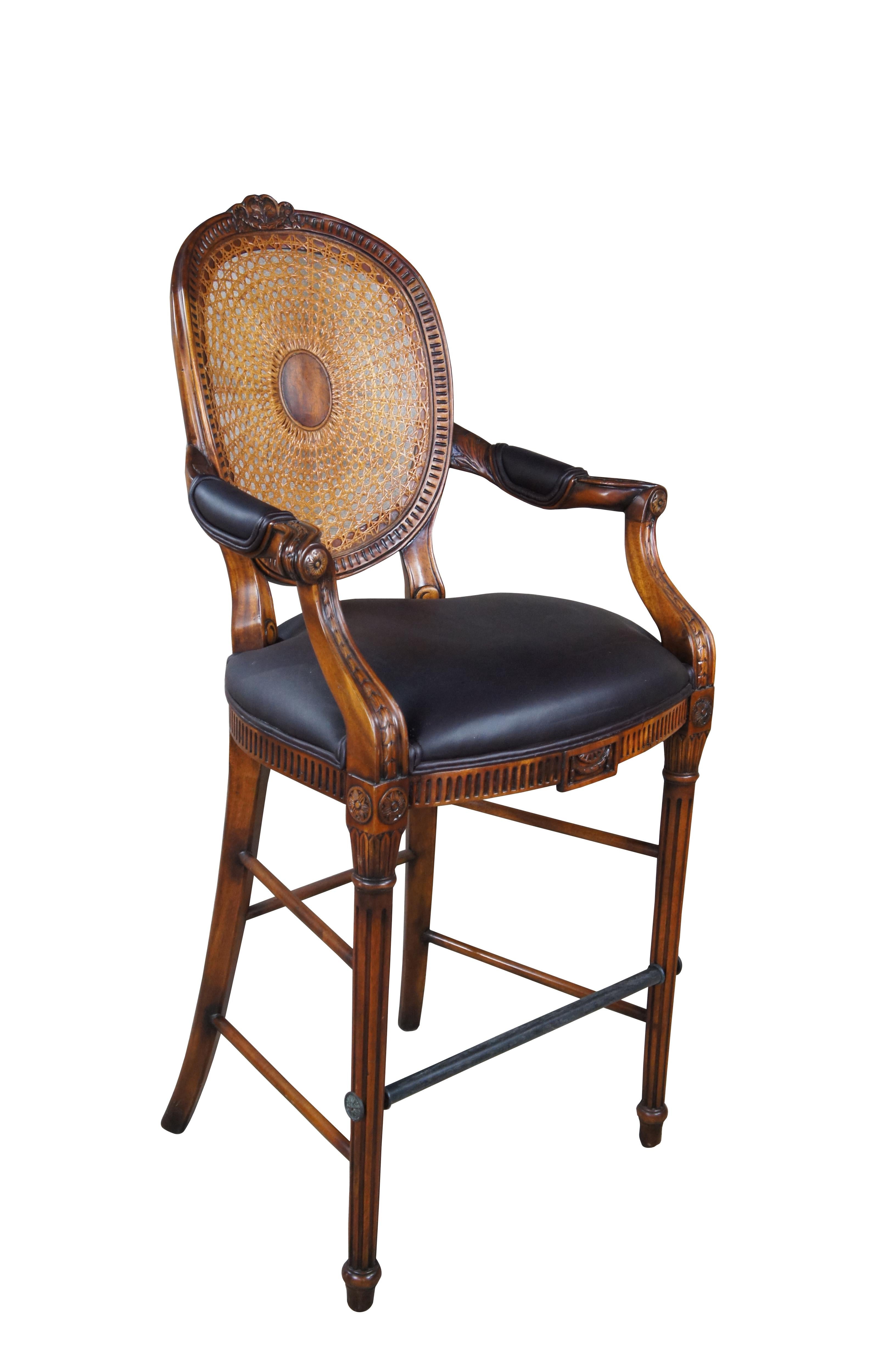 Theodore Alexander French Louis XV Bar Stool. Made from mahogany with cane back, padded arms, brown leather seat and turned fluted legs leading to foot rest and turnip feet.   The chair is carved with traditional French medallions, fluting and