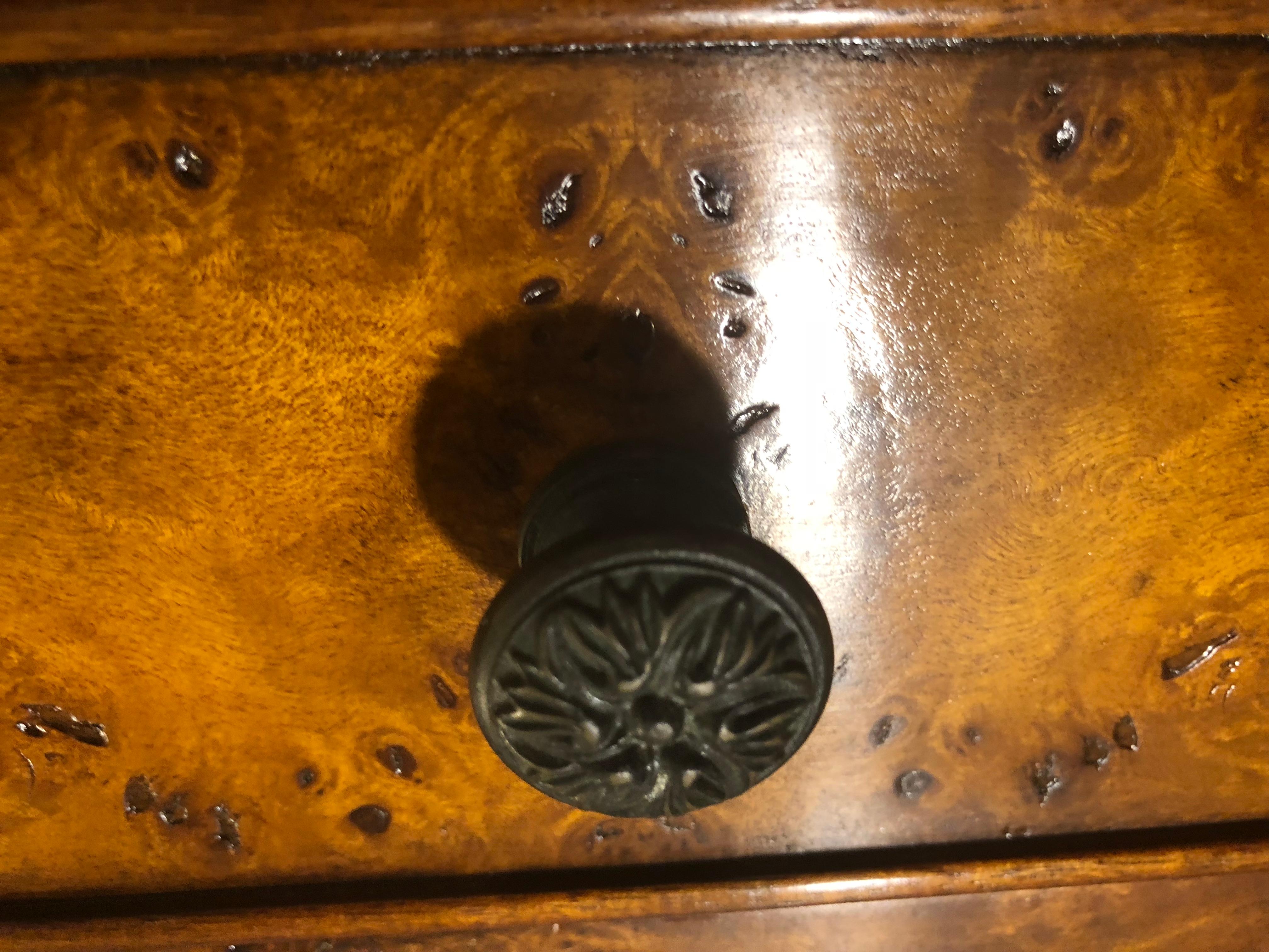A Theodore Alexander Louis XVI style console table in a fine burled mahogany or walnut. This beautiful console features four drawers on a bronze galleried tabletop having a lower shelving In the bottom. The console table is an excellent addition