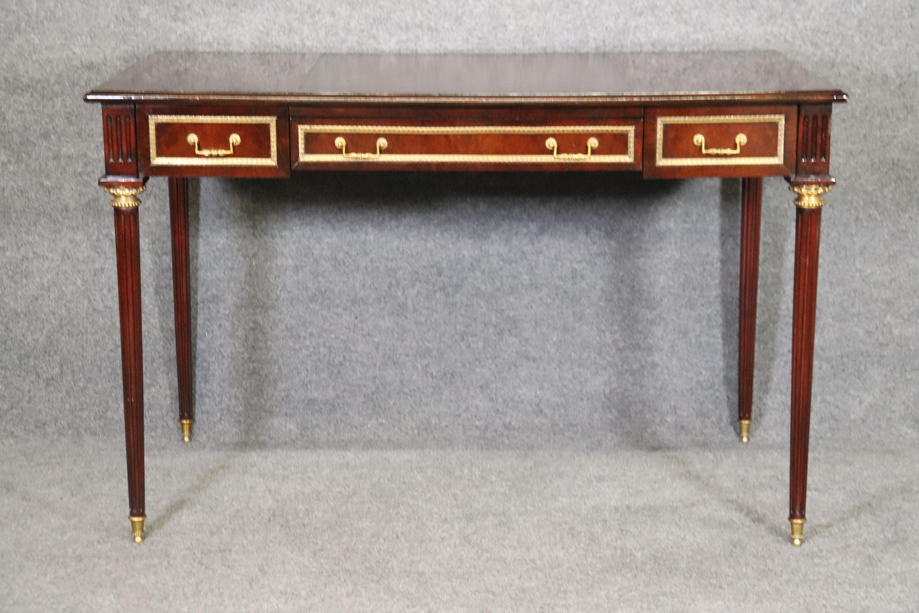 This is a great Louis XVI style desk made by Theodore Alexander. Made of the highest quality this desk has a leather insert of the top of the desk perfect for writing or to place your computer or laptop. The desk is accompanied with brass hardware