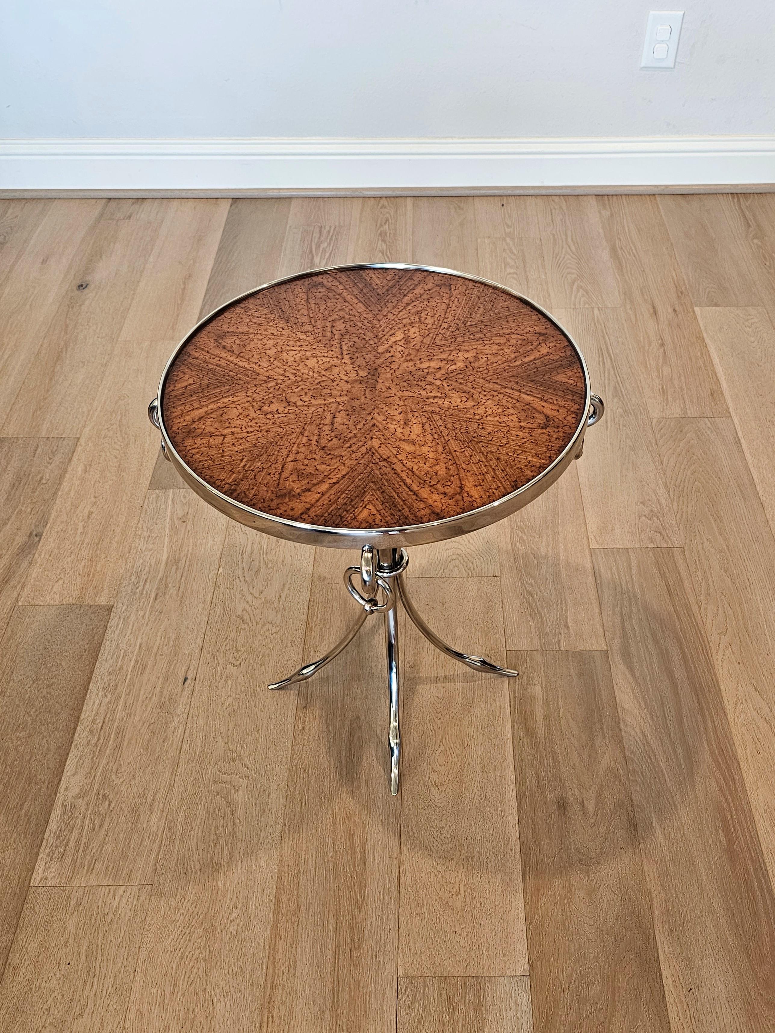 A stunning contemporary Neoclassical modern guéridon side table by fine quality luxury furniture maker Theodore Alexander.

Having a round top with visually striking radiating matched burl wood top, high quality polished chromed base with ring