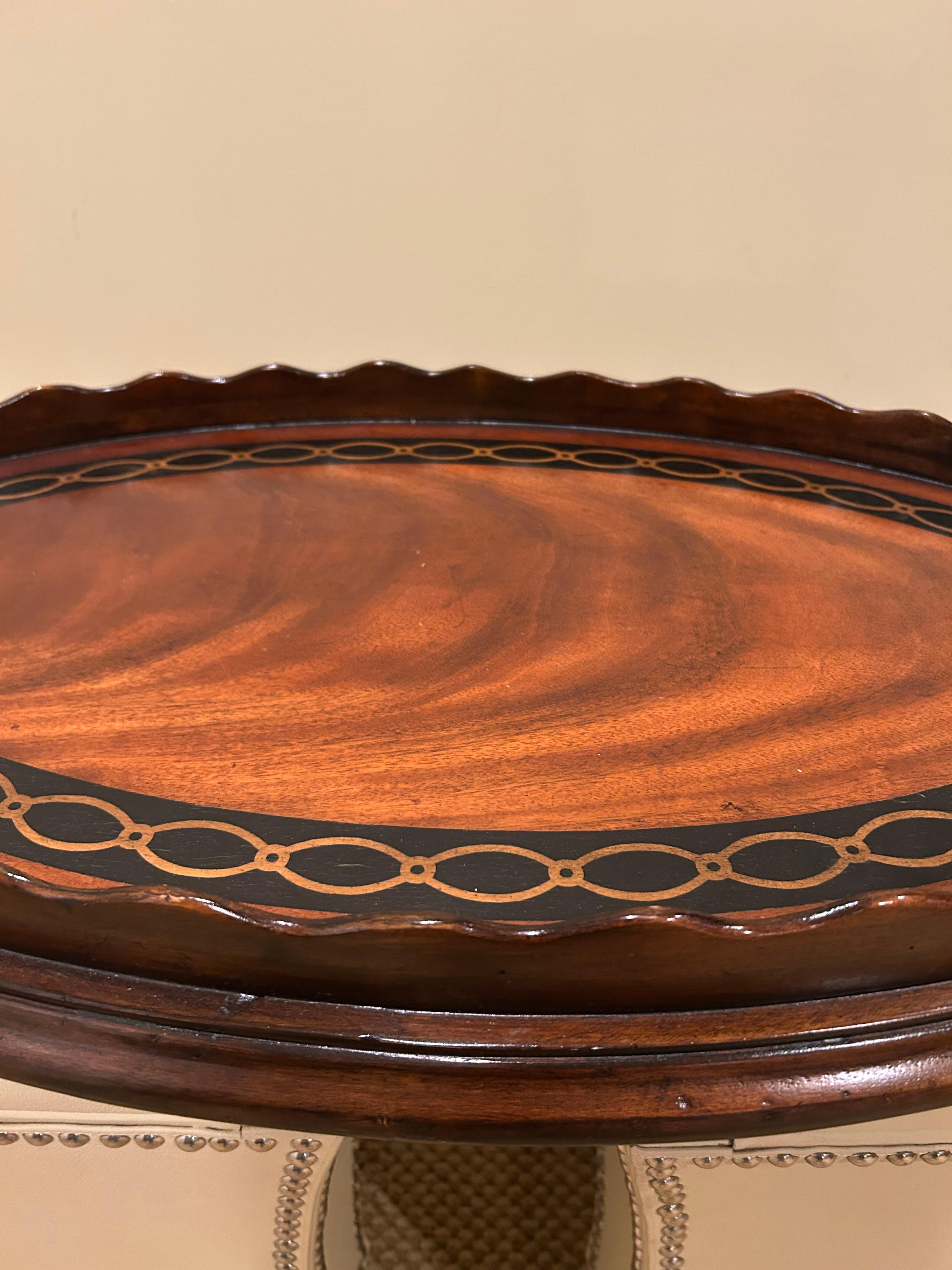 Stunning oval mahogany serving tray having pie crust edge and chain link inlaid design.