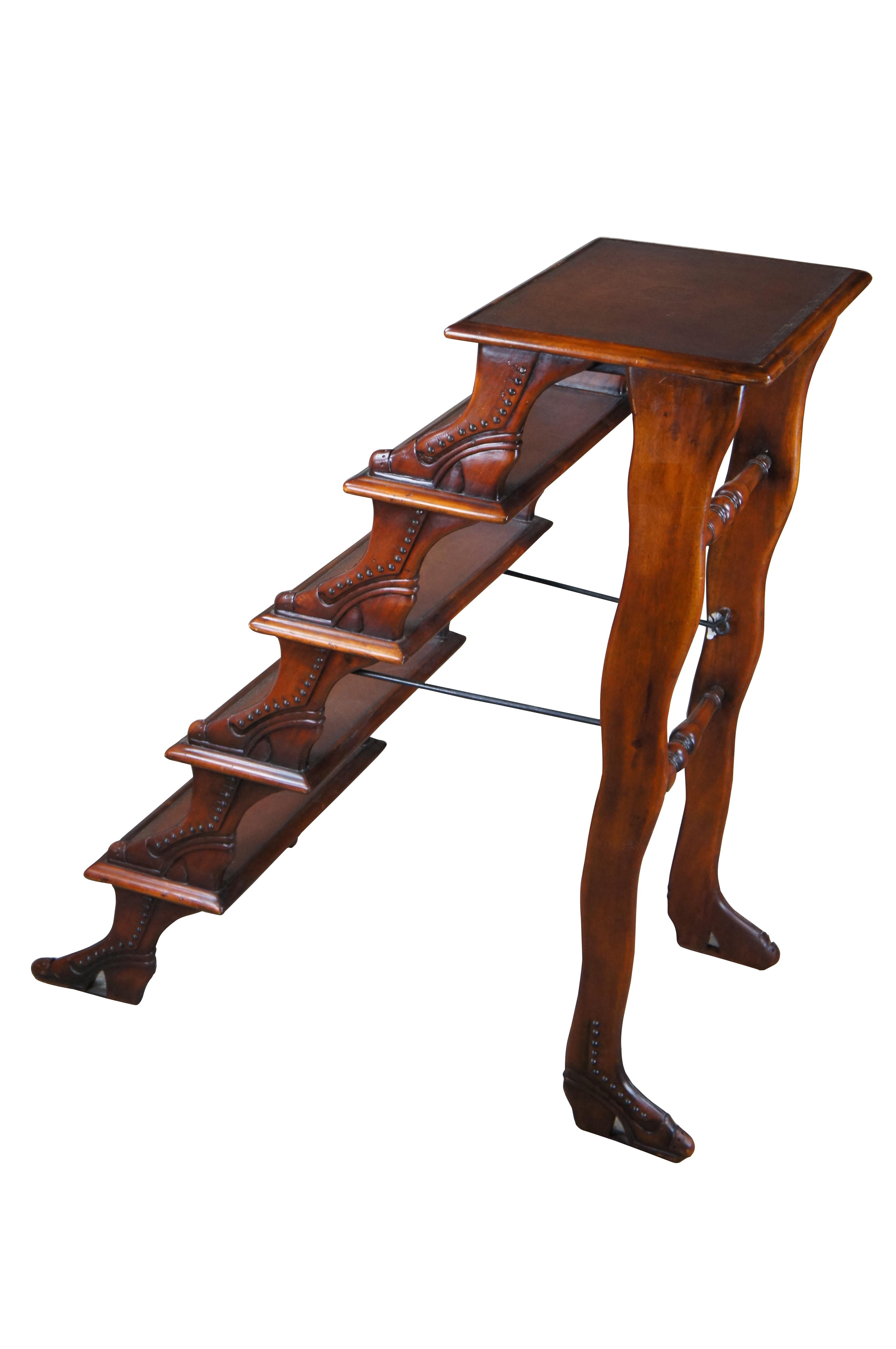Aesthetically pleasing set of library steps / staircase by Theodore Alexander, Circa late 20th century. Designed from mahogany with a shoe or boot form and brown tooled leather steps. Features 5 steps and a foldable frame for stowing away. When open