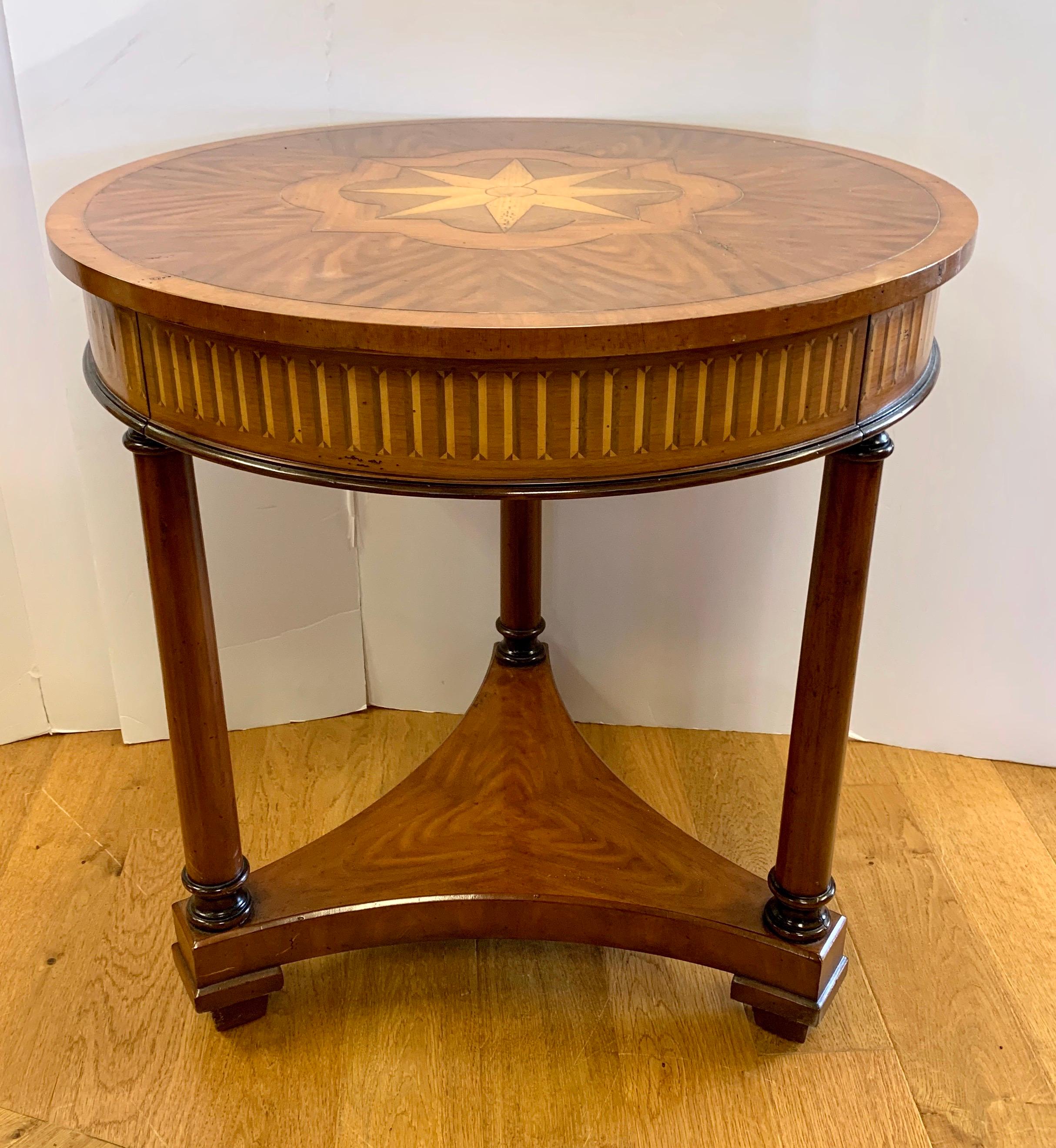 Elegant Theodore Alexander round marquetry table with one drawer. It is supported by three legs.
Now, more than ever, home is where the heart is.