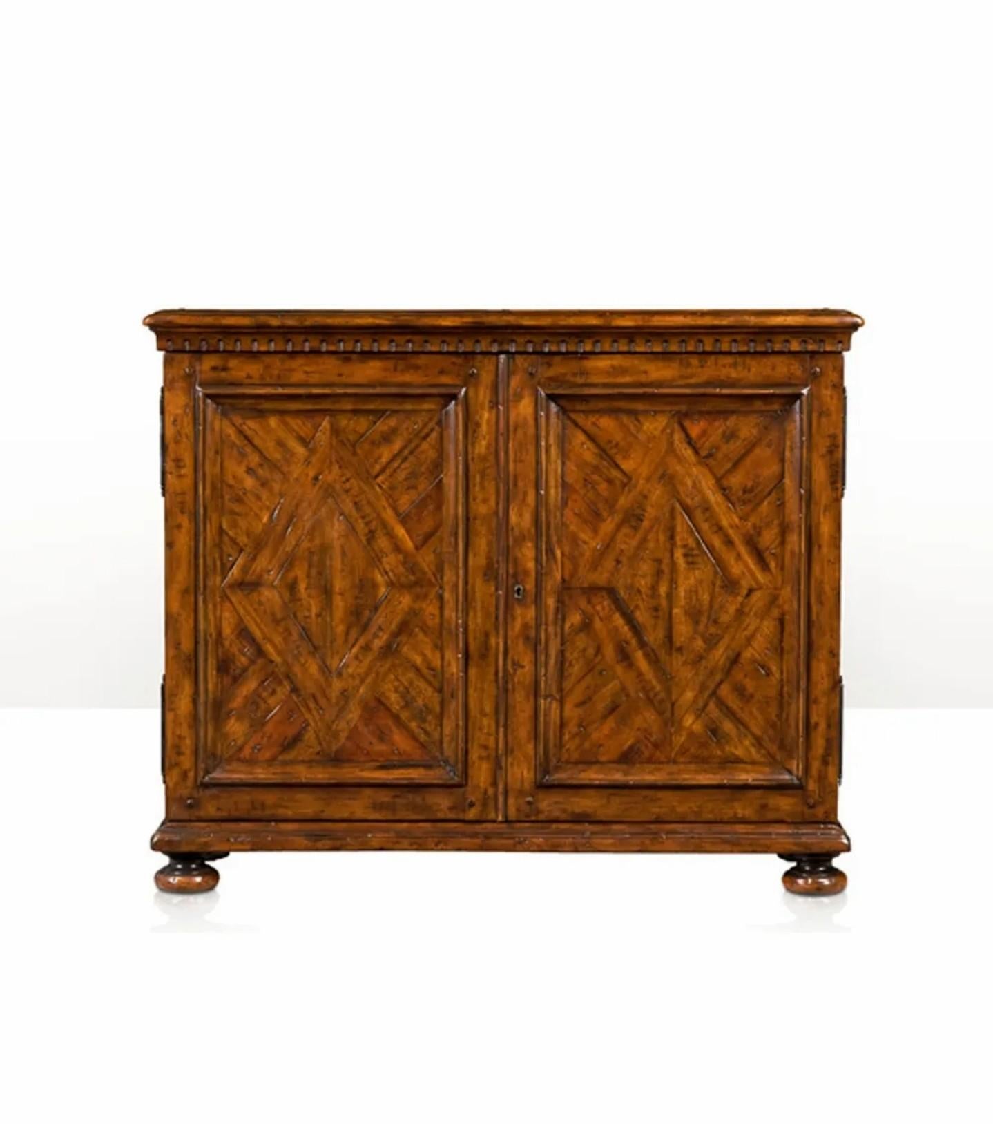 A rare fine quality Theodore Alexander Sir John's Cabinet exquisitely handcrafted of reclaimed antique wood and part of the iconic Castle Bromwich Collection. 

The Castle Bromwich name comes from an Elizabethan manor house in rural England.