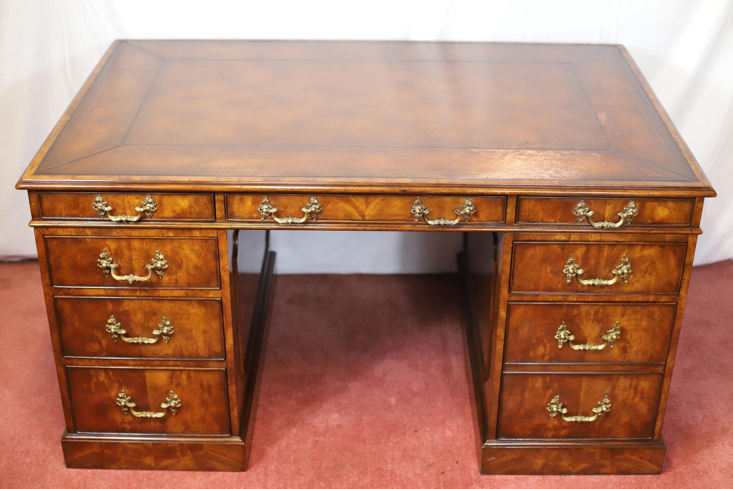 We delight to offer for sale this fine Mahogany twin pedestal desk , manufactured by Theodore Alexander after a design by Thomas Chippendale , the rectangular top inset with a gilt tooled tan leather writing surface, the frieze with three drawers to