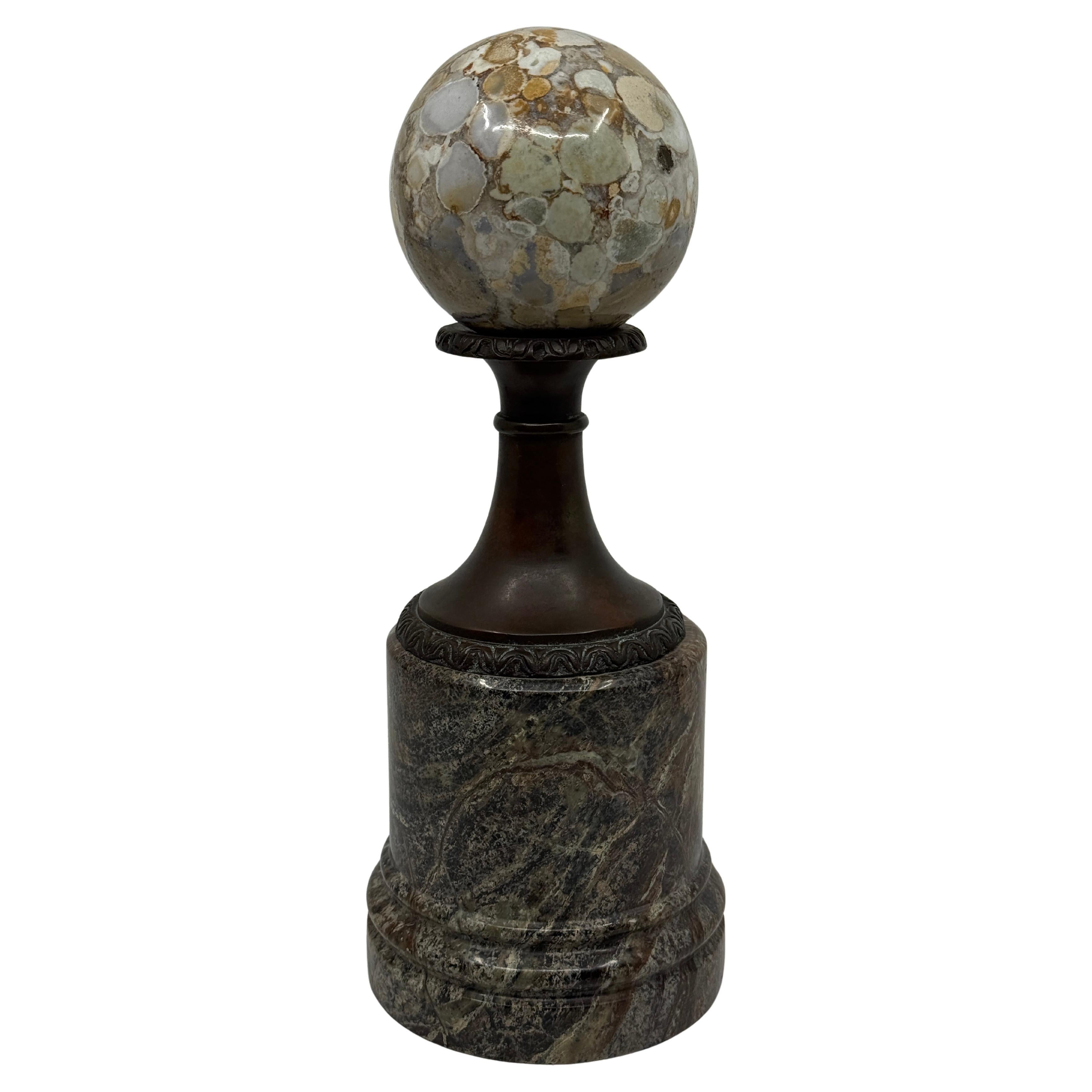 Un bonito homenaje de gran viaje neoclásico de alta calidad de Theodore y Alexander. Presenta un ejemplar de esfera de mármol sobre una base montada de bronce y mármol. Está fundida en bronce y montada sobre una hermosa base de mármol. Bien
