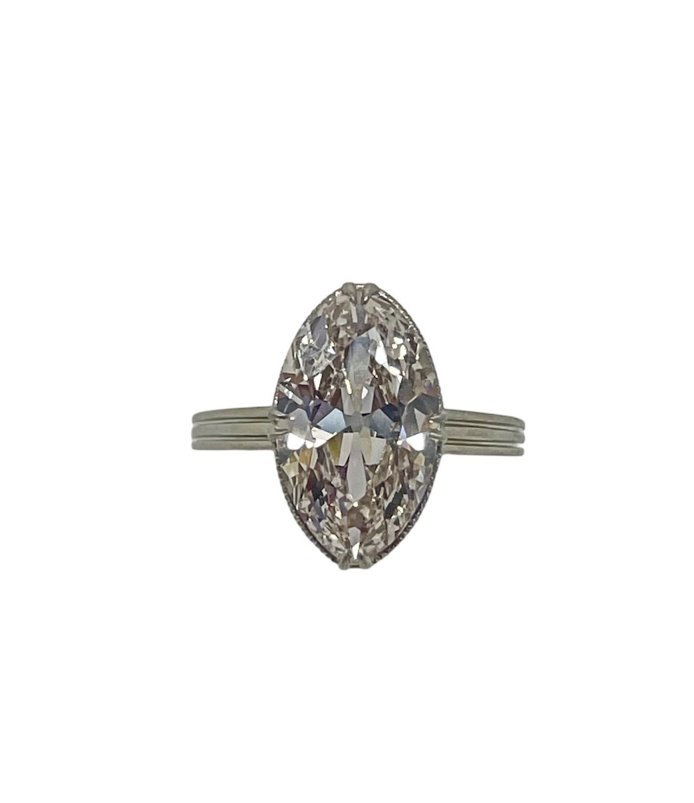This unique and beautifully hand crafted ring by influential New York Jeweler Theodore B. Starr, displays an antique marquise cut diamond weighing 2.95 carats with a hidden halo made up of old cut diamonds. Mounted in platinum with delicate claw