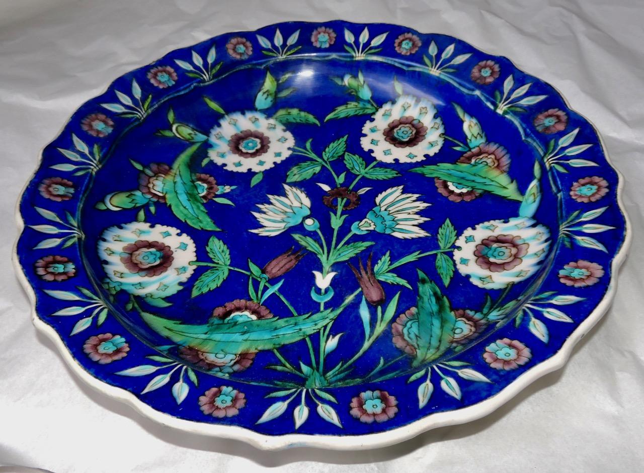 A fretted enameled Faience impressive charger
Iznik-style floral decoration in enamelled cream, green and pale mauve colors on a deep blue ground
Impressed Uppercase Mark TH.DECK
circa 1875.

A near identical charger by Théodore Deck