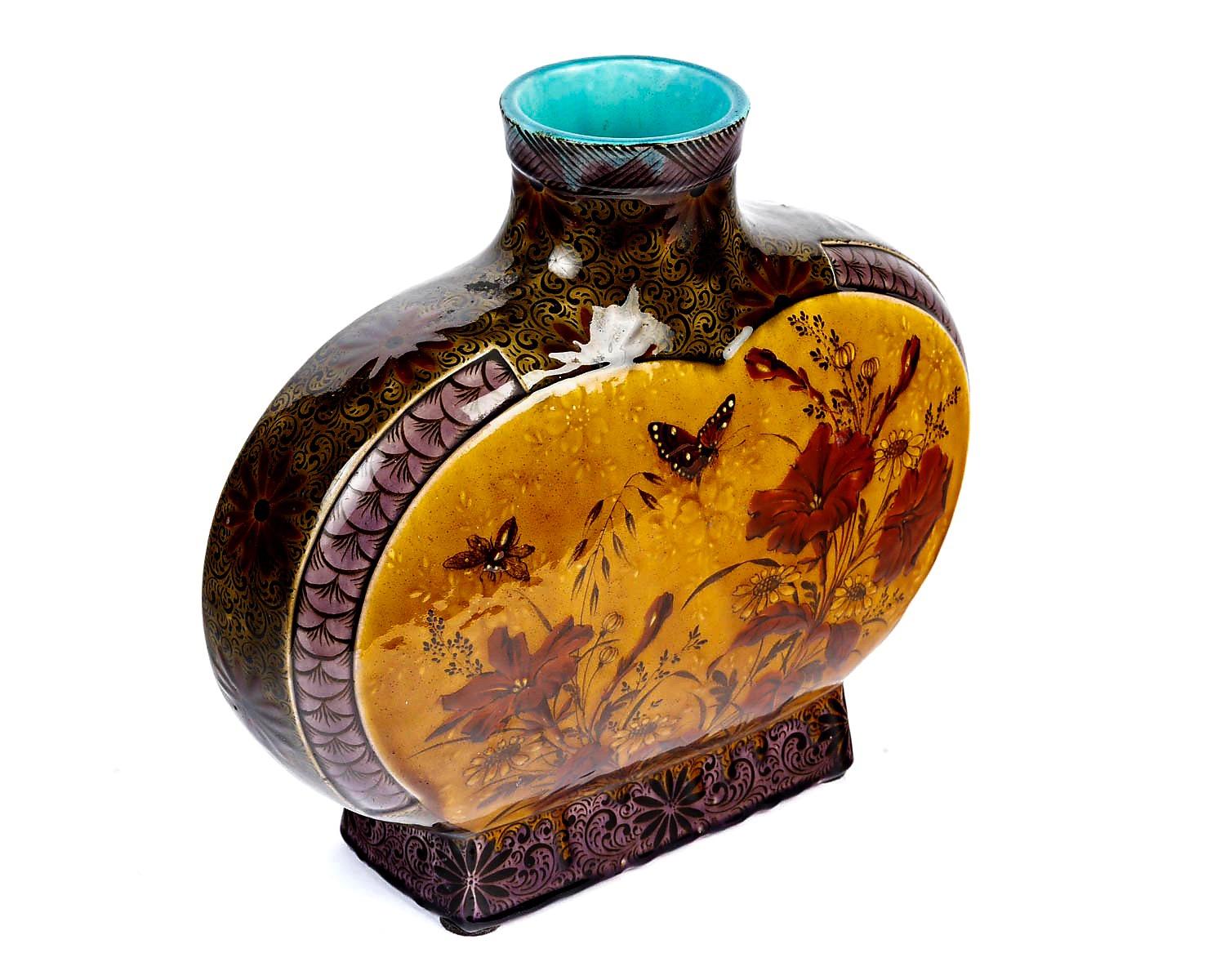 Théodore Deck (1823-1891)
Gourd shape vase with a spherical body and straight neck
Polychrome glazed earthenware designed on both sides with a bird, butterflies, a bee, and flowers on an ochre background.
The neck and borders decorated with fish