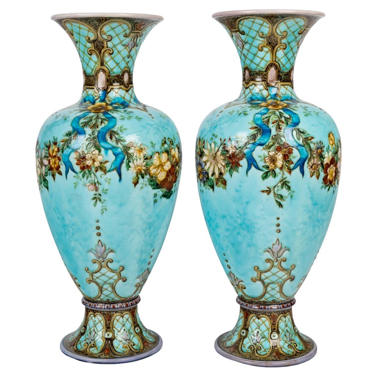 Théodore Deck (1823-1891) Large Pair of Faience Vases circa 1870

Large pair of polychrome enameled faience baluster shape vases
Rich decoration of garlands of flowers and ribbons on a cloudy sky-blue background, the collar and base of the vase