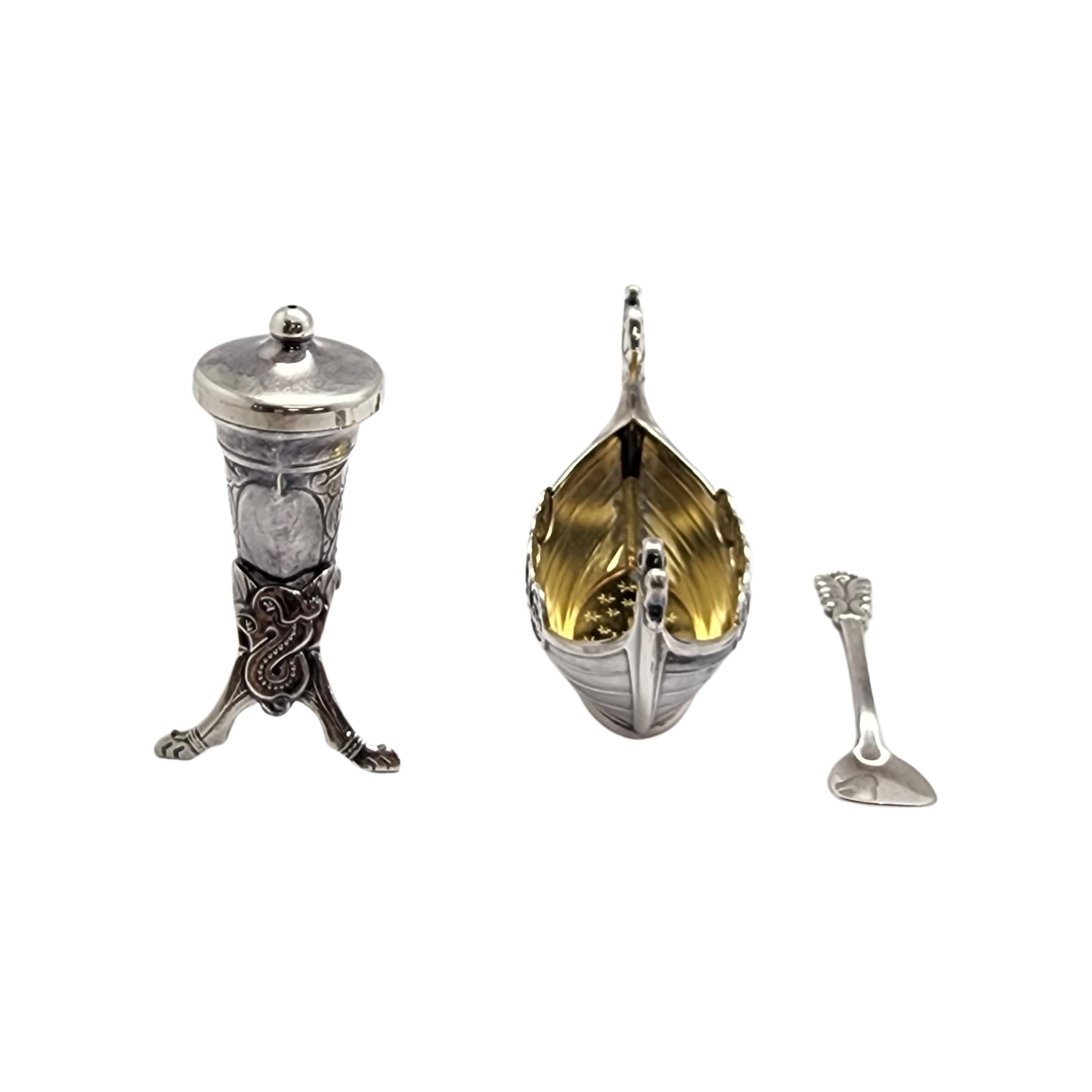 Sterling silver Viking ship salt cellar with spoon and Viking horn pepper shaker by Theodor Olsens of Norway.

Ornate Viking horn pepper shaker featuring one small hole at the center of the removable lid. Beautiful Viking ship salt cellar featuring