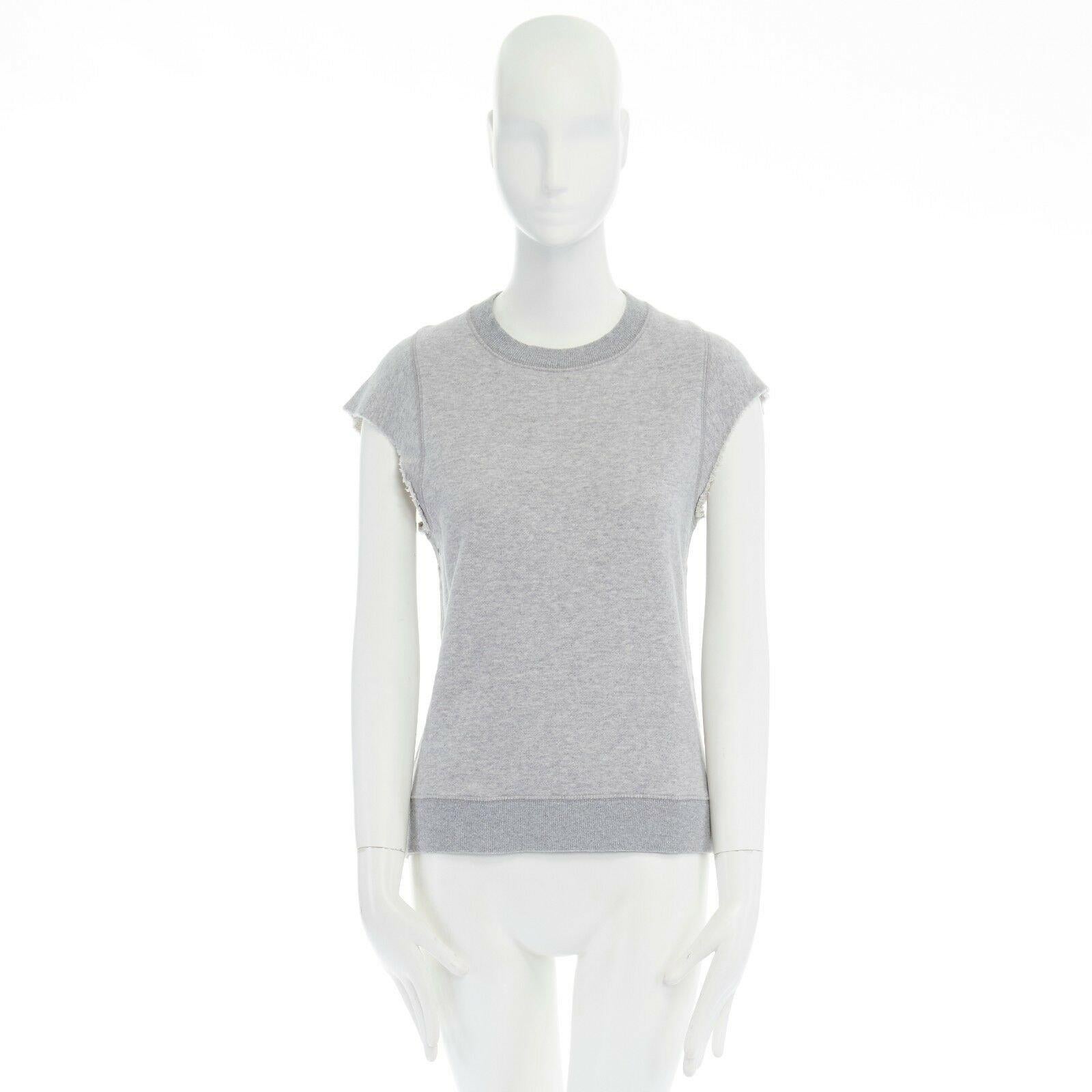 THEORY 38 light grey raw cut sleeves cotton jersey sleeveless sweater top XS 
Reference: LNKO/A00755 
Brand: Theory 
Material: Cotton 
Color: Grey 
Pattern: Solid 
Extra Detail: Cotton, polyethene. Ribbed rounded neck. Raw cut sleeves. Tonal grommet