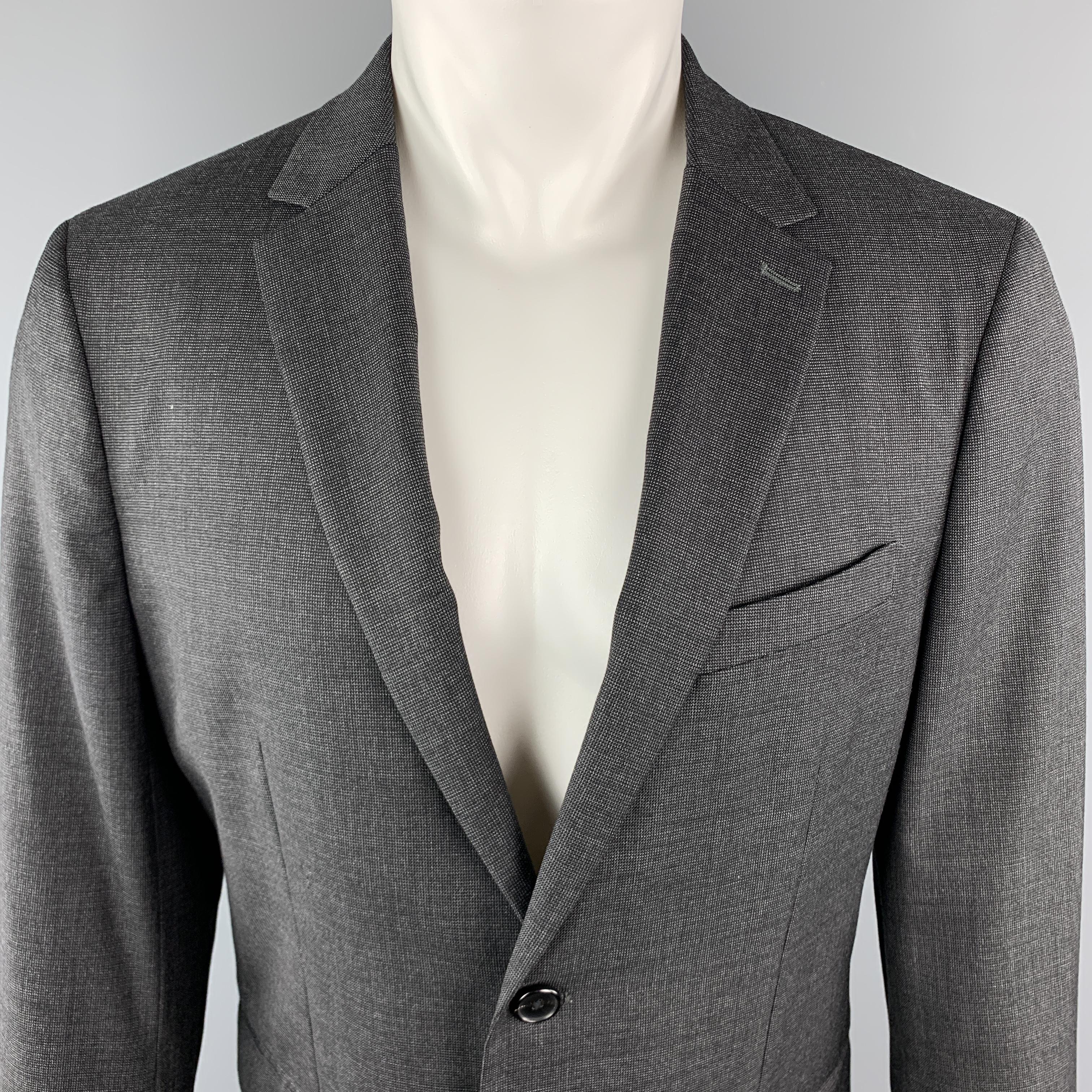THEORY Sport Coat comes in a charcoal tone in a nailhead wool material, with a notch lapel, slit and flap pockets, two buttons at closure, single breasted, buttoned cuffs, and a single vent at back.

Excellent Pre-Owned Condition.
Marked: 40