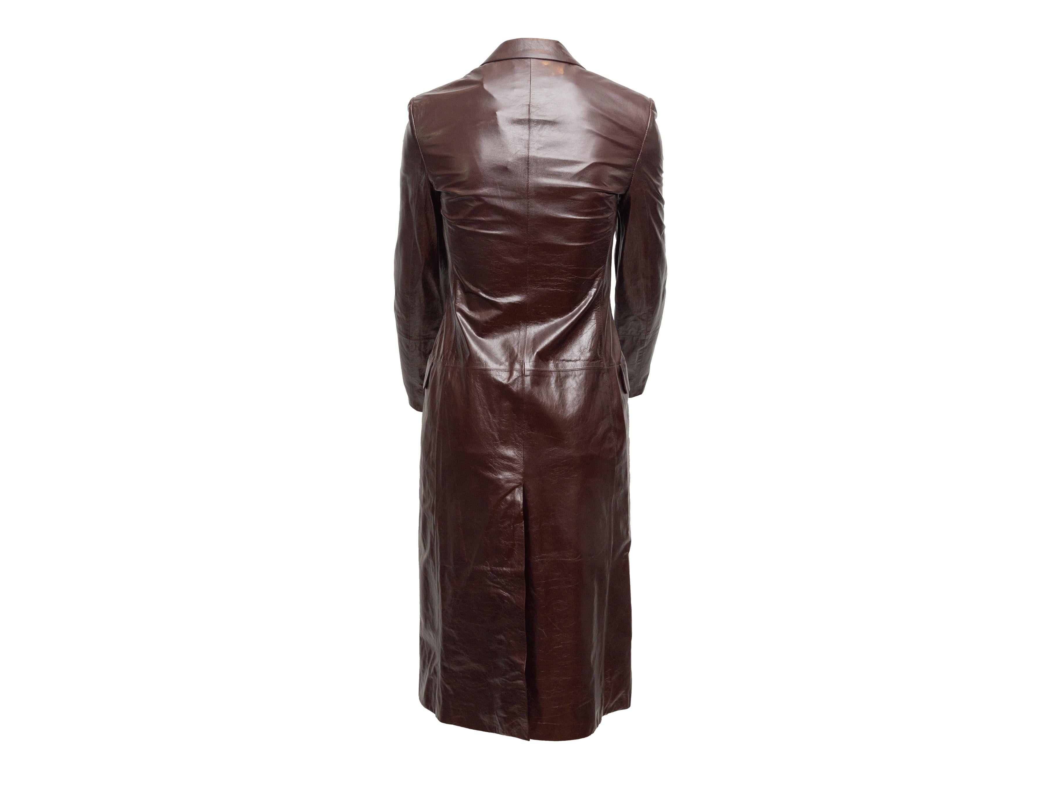 Product details: Dark brown long leather coat by Theory. Notched lapel. Dual hip pockets. Single button closure at front. 32