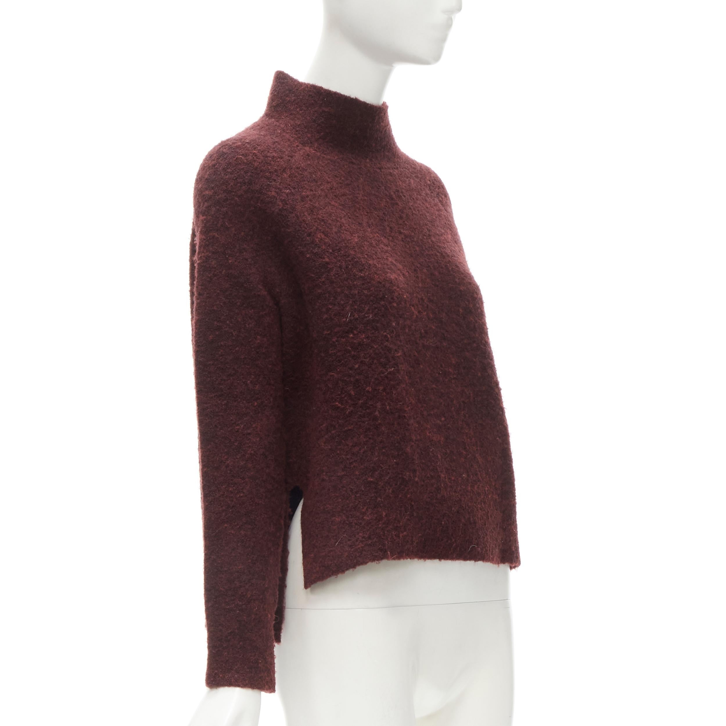 THEORY dark red wool blend fuzzy stand collar step hem sweater XS
Brand: Theory
Material: Wool
Color: Red
Pattern: Solid
Extra Detail: Stand collar. Raglan sleeve. High low step hem.
Made in: China

CONDITION:
Condition: Excellent, this item was