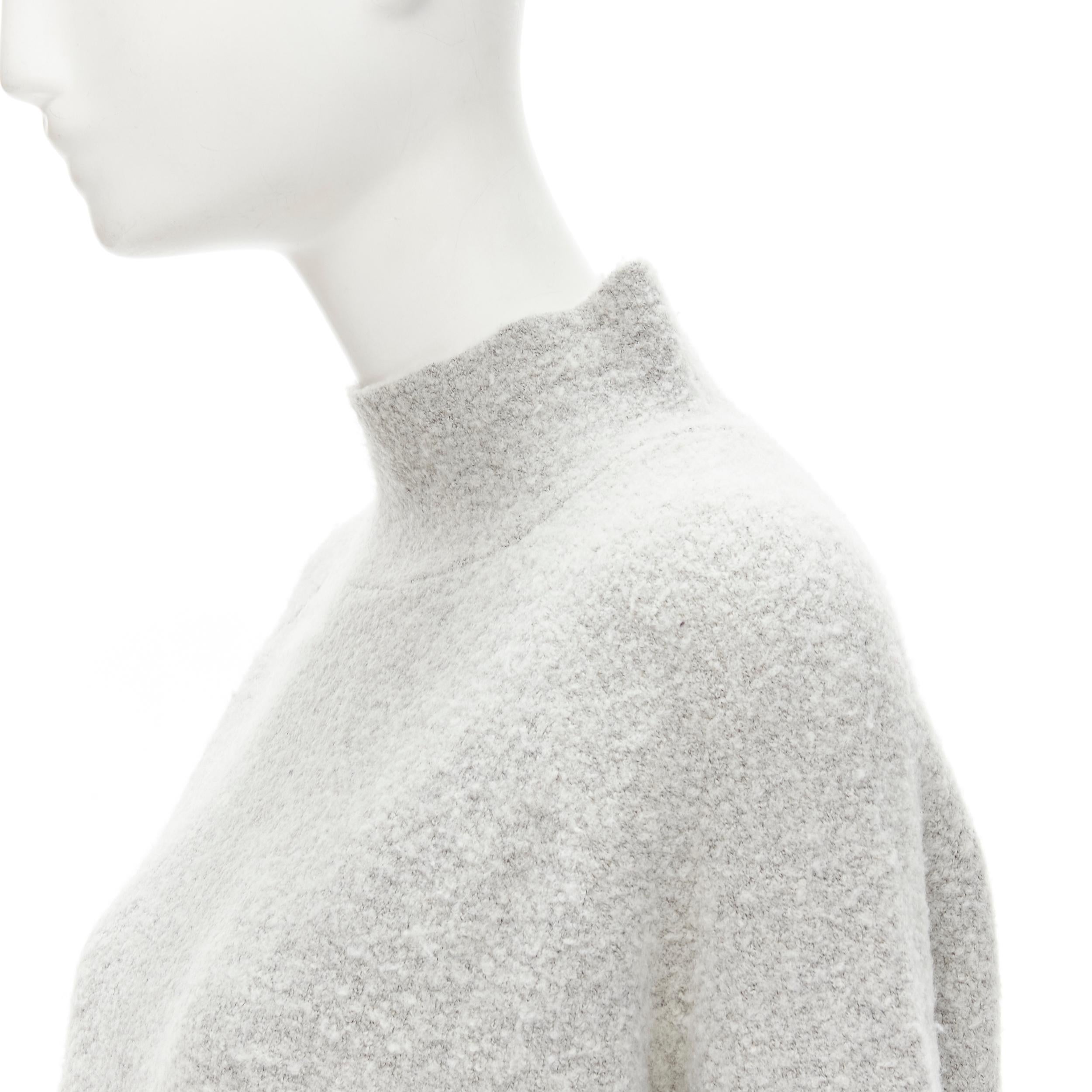 THEORY grey wool blend fuzzy stand collar step hem sweater XS
Brand: Theory
Material: Wool
Color: Grey
Pattern: Solid
Extra Detail: Stand collar. Raglan sleeve. High low step hem.
Made in: China

CONDITION:
Condition: Excellent, this item was