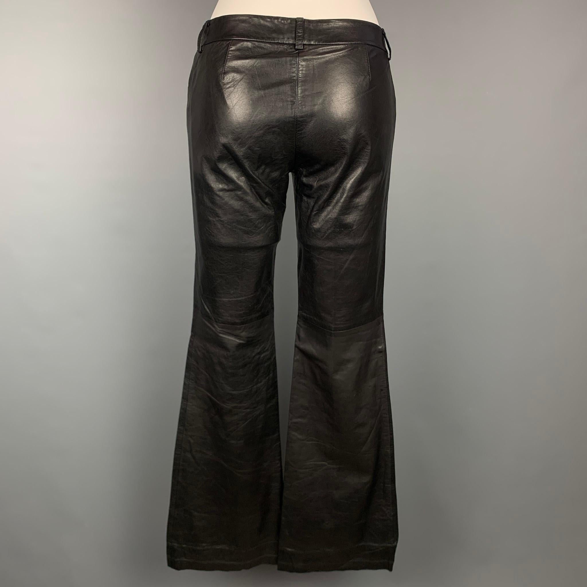 THEORY dress pants comes in a black leather featuring a boot cut style, front tab, and a zip fly closure. 

Very Good Pre-Owned Condition.
Marked: 2
Original Retail Price: $995.00

Measurements:

Waist: 29 in.
Rise: 7.5 in.
Inseam: 34 in. 
