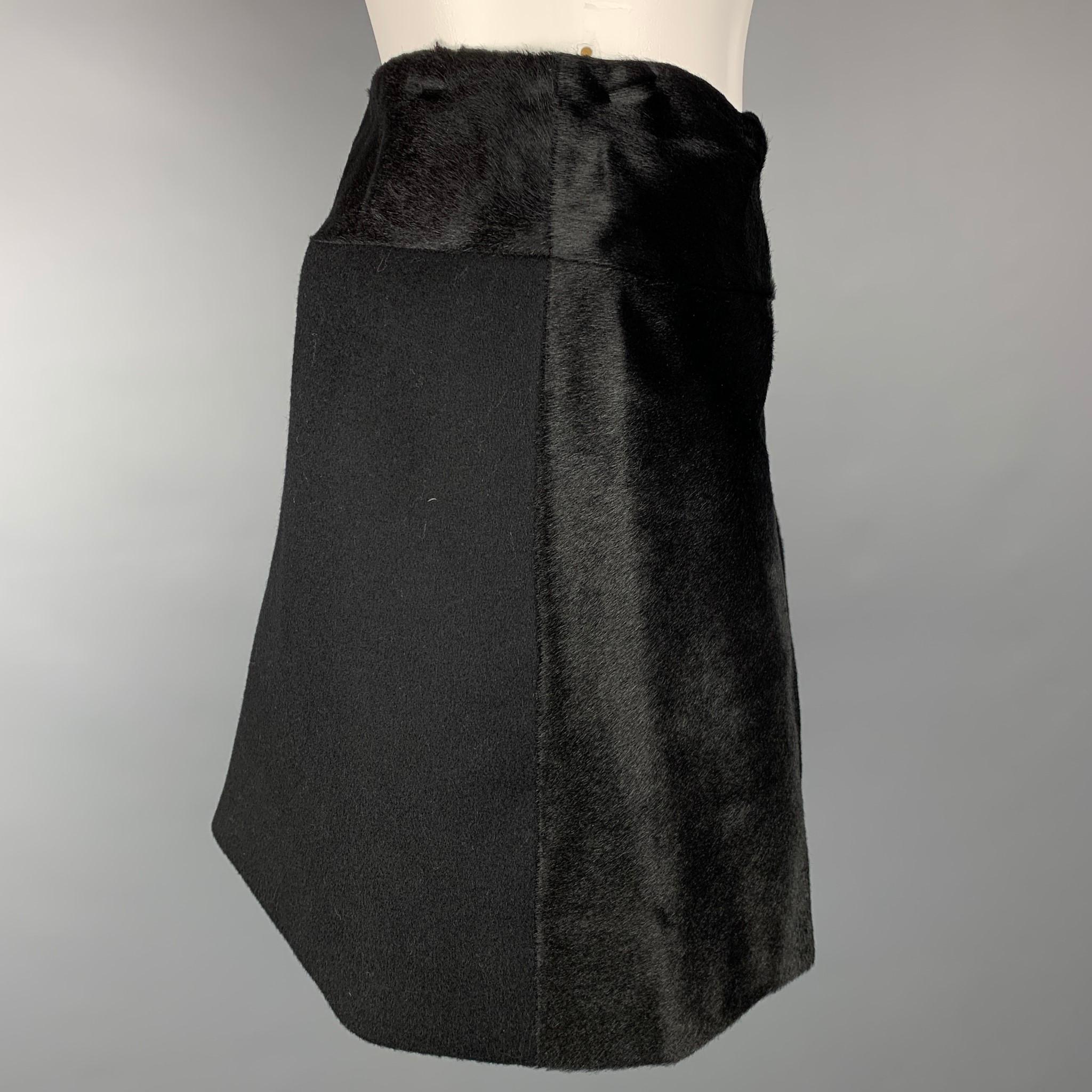 THEORY mini skirt comes in a black wool / nylon with a calf hair panel design featuring wrap style and a front tab closure.

New With Tags. 
Marked: 2

Measurements:

Waist: 29 in.
Hip: 34 in.
Length: 16 in. 