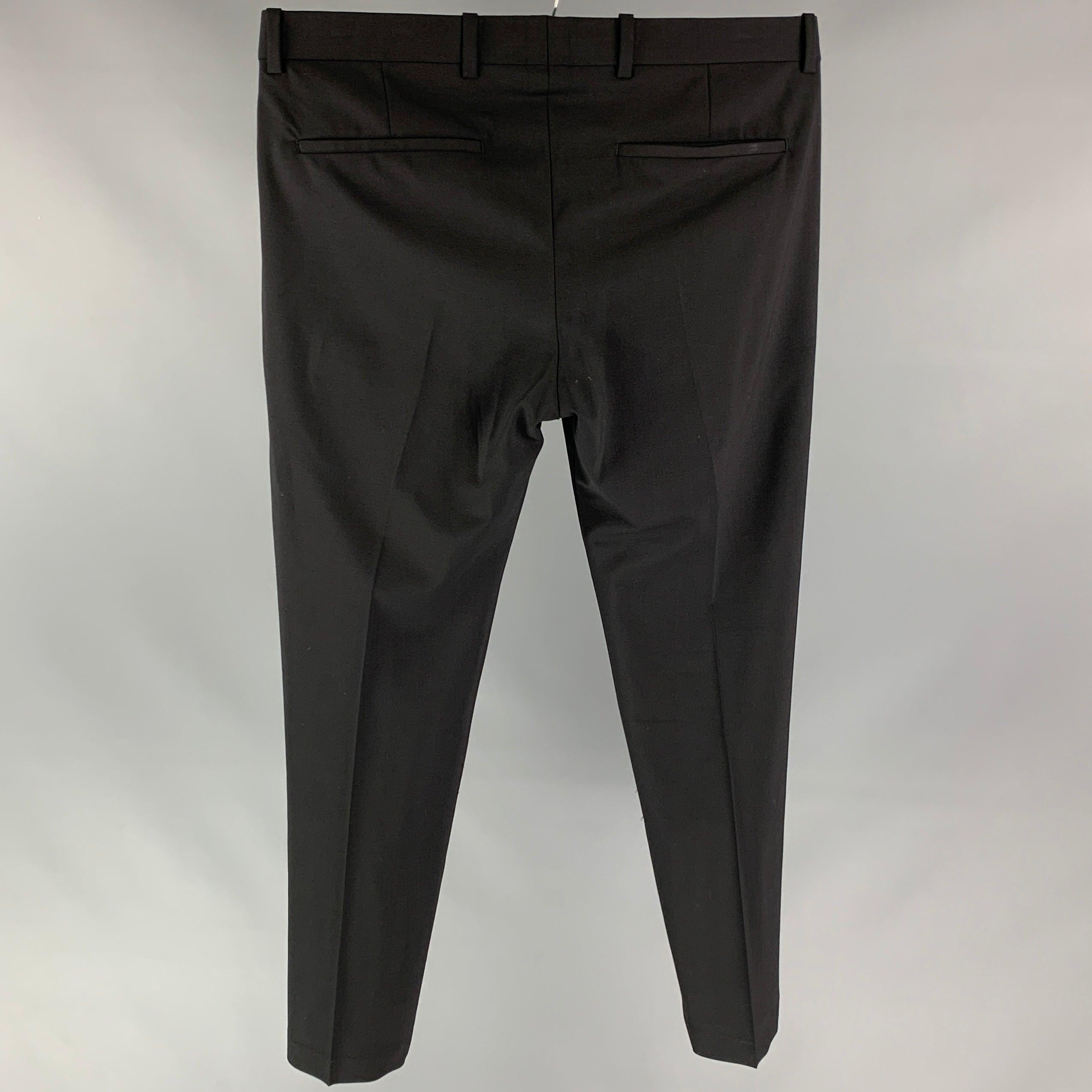 THEORY dress pants comes in a black wool / lycra featuring a flat front, slim fit, front tab, and a zip fly closure.Very Good Pre-Owned Condition. 

Marked:   31 

Measurements: 
  Waist: 34 inches  Rise: 11 inches  Inseam: 28 inches 
  
  
