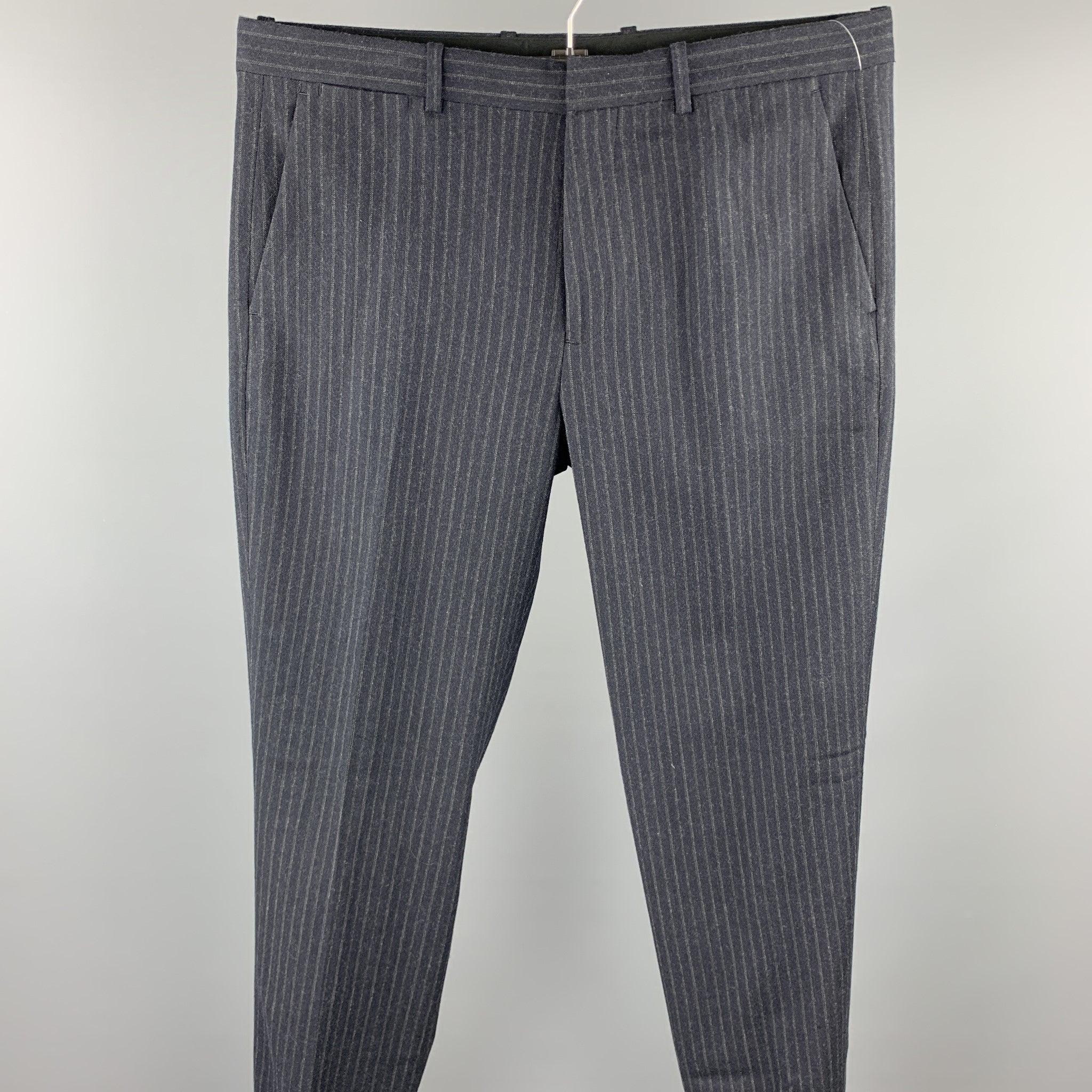 THEORY dress pants comes in a charcoal stripe wool featuring a flat front, cuffed leg, and a zip fly closure.
Excellent
Pre-Owned Condition. 

Marked:   34 

Measurements: 
  Waist: 36 inches 
Rise: 10 inches 
Inseam: 32 inches 
  
  
 
Reference: