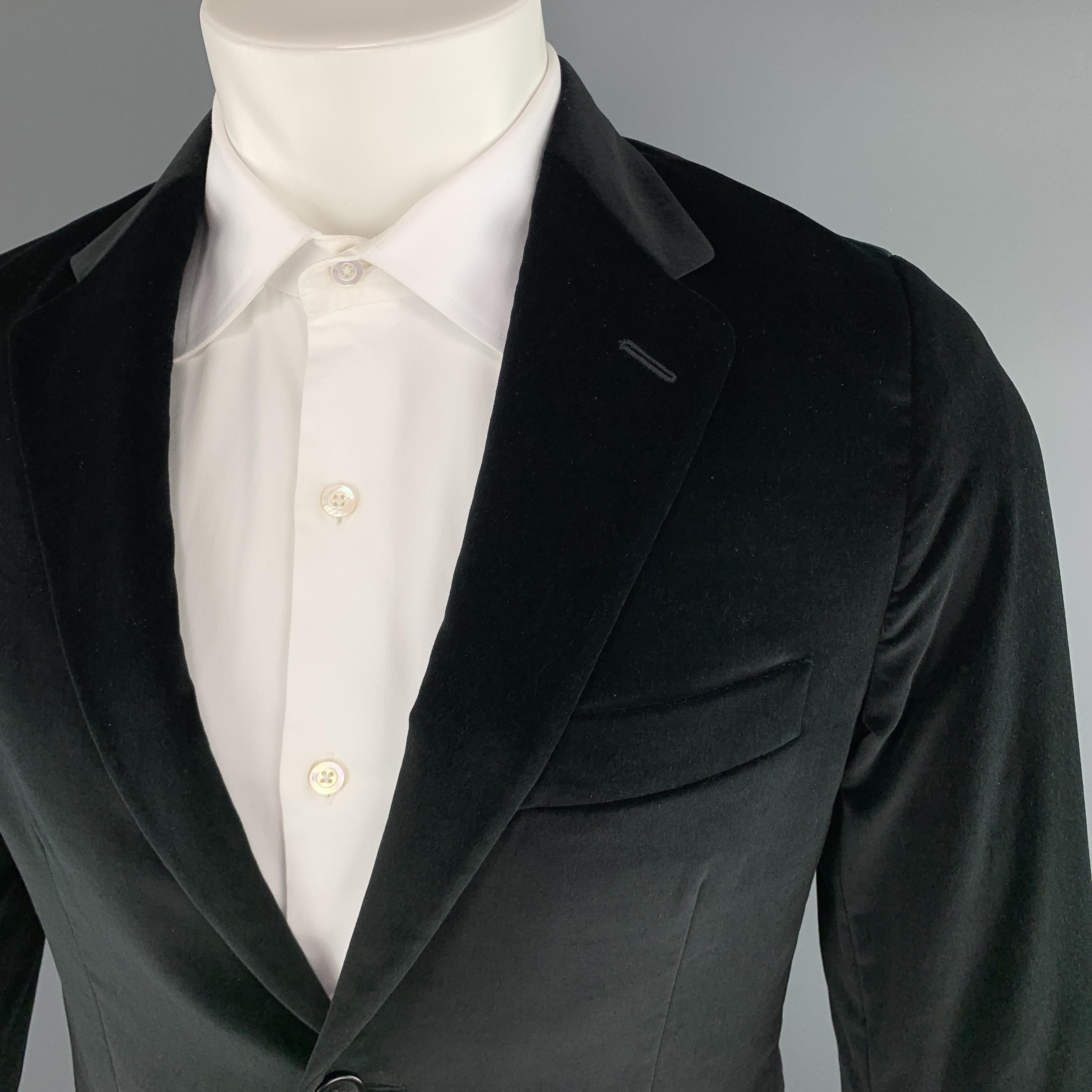 THEORY sport coat comes in black velvet with a notch lapel, single breasted, two button front, and single vented back. Made in Italy.

Excellent Pre-Owned Condition.
Marked: 38 R

Measurements:

Shoulder: 15 in.
Chest: 40 in.
Sleeve: 25 in.
Length: