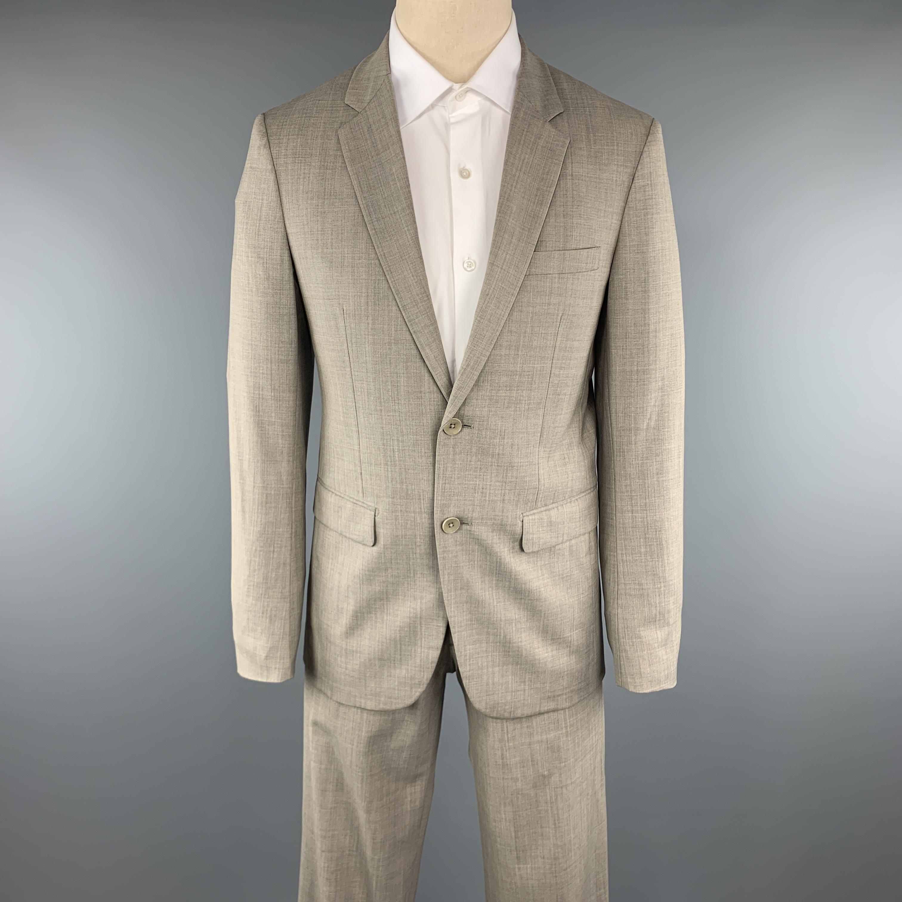 THEORY Suit comes in a gray wool and includes a single breasted, two button sport coat with a notch lapel and matching front trousers. 

Excellent Pre-Owned Condition.
Marked: 38

Measurements:

-Jacket
Shoulder: 17.5 in.
Chest: 38 in. 
Sleeve: 26
