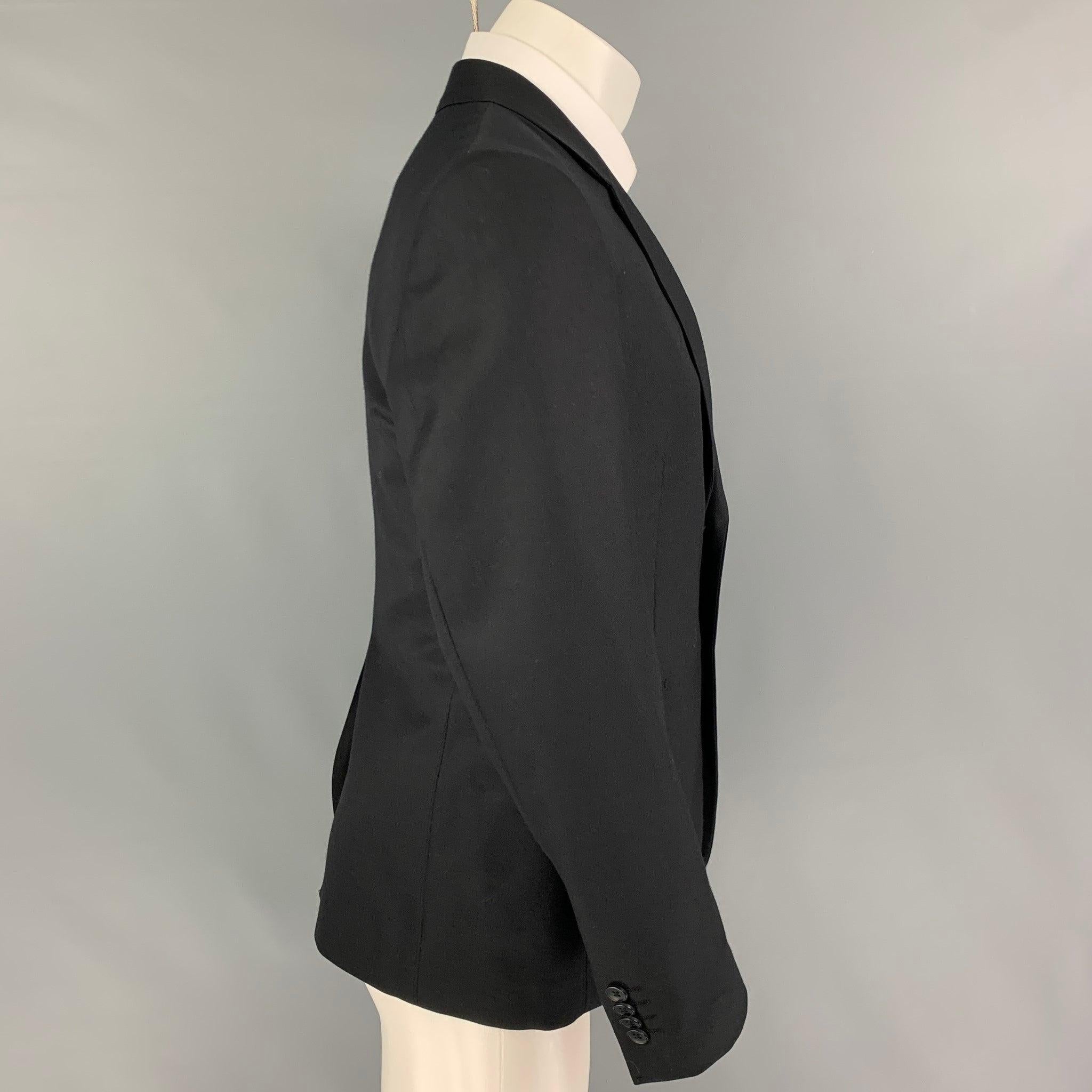 THEORY
sport coat comes in a black wool with a full liner featuring a notch lapel, flap pockets, single back vent, and a double button closure.Very Good Pre-Owned Condition.  

Marked:   38 

Measurements: 
 
Shoulder: 17 inches  Chest: 38 inches 