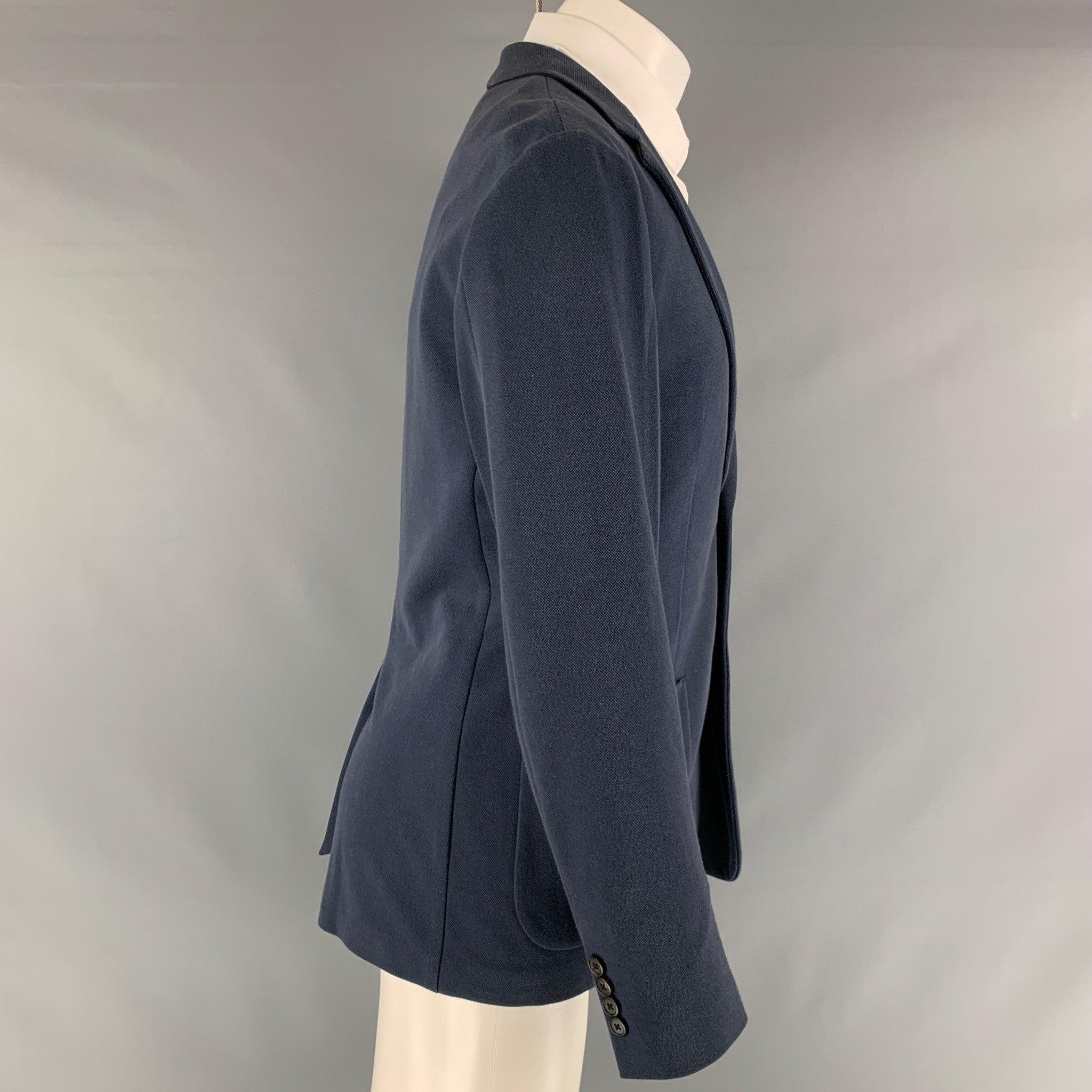 THEORY sport coat comes in a navy cotton blend material featuring a notch lapel, patch pockets, and a double button closure.Very Good Pre-Owned Condition. Moderate Collar Fading. 

Marked:   40  

Measurements: 
 
Shoulder: 18 inches Chest: 40