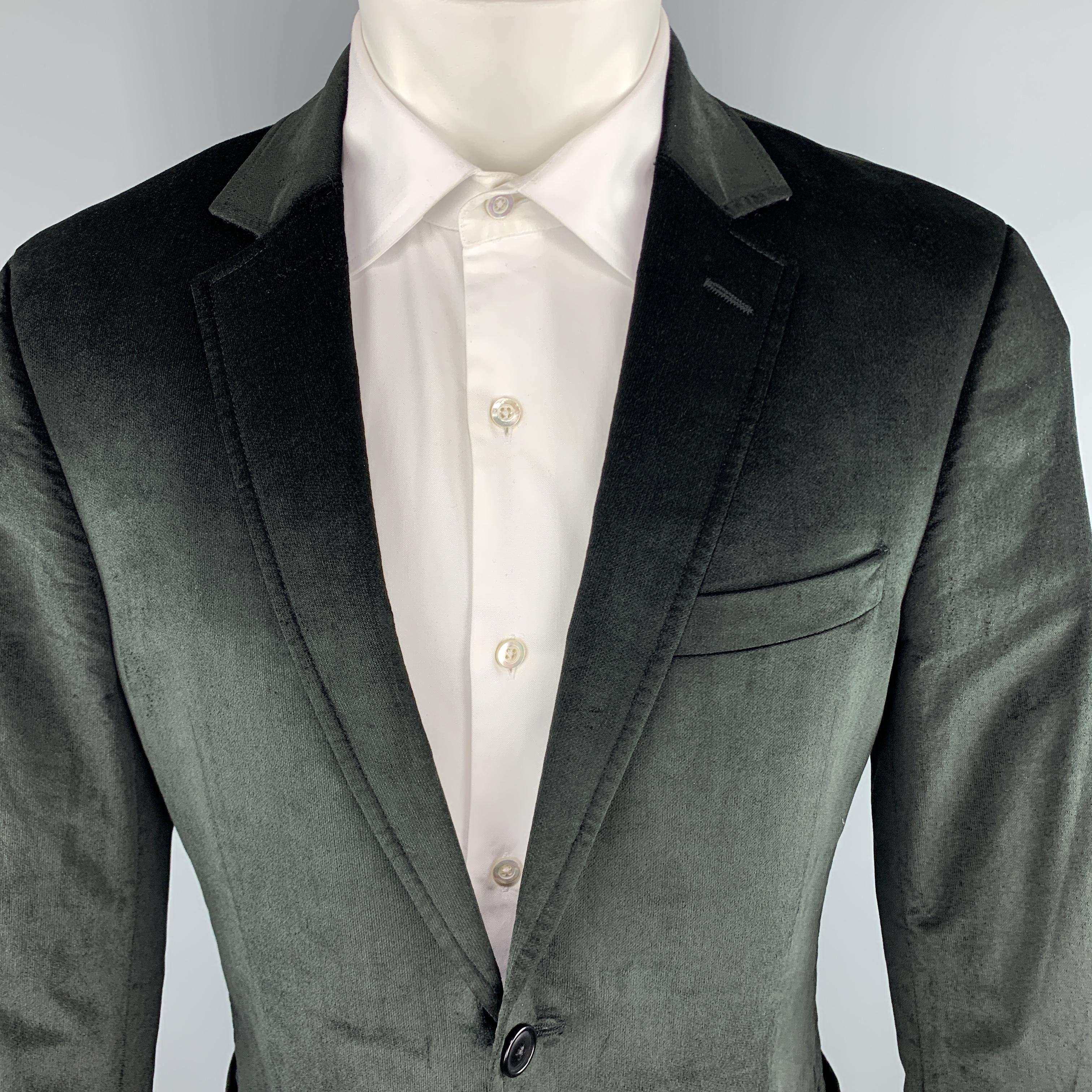 THEORY sport coat comes in black velvet with a notch lapel, single breasted, two button front, and patch pockets. Made in Canada.

Very Good Pre-Owned Condition.
Marked: 40 REG

Measurements:

Shoulder: 18 in.
Chest: 42 in.
Sleeve: 25 in. 
Length: