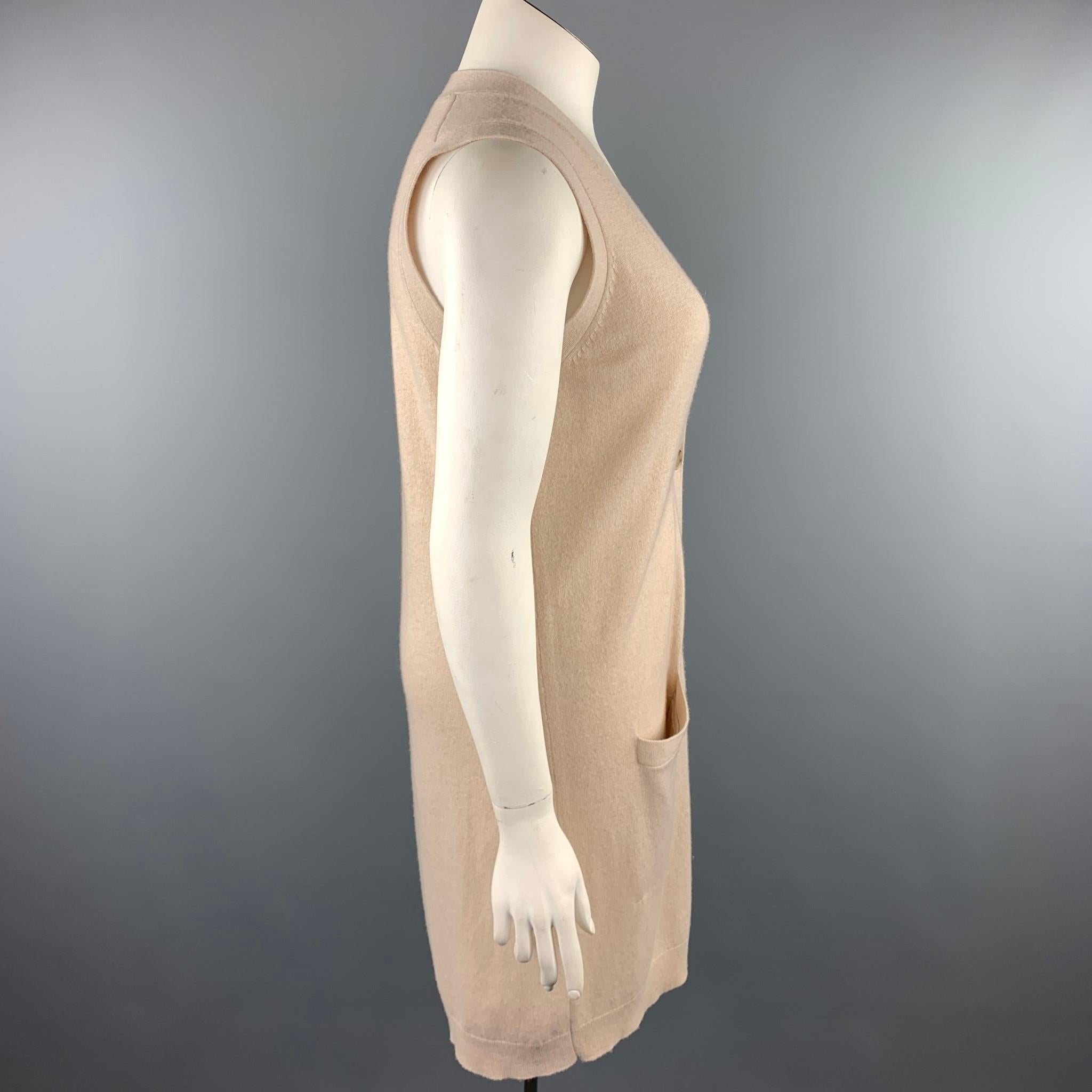 THEORY cardigan comes in a beige knitted cashmere featuring a sleeveless style, front pockets, and a buttoned closure.

Good Pre-Owned Condition.
Marked: L

Measurements:

Shoulder: 15.5 in. 
Bust: 37 in. 
Length: 37 in. 

SKU: 97194
Category: