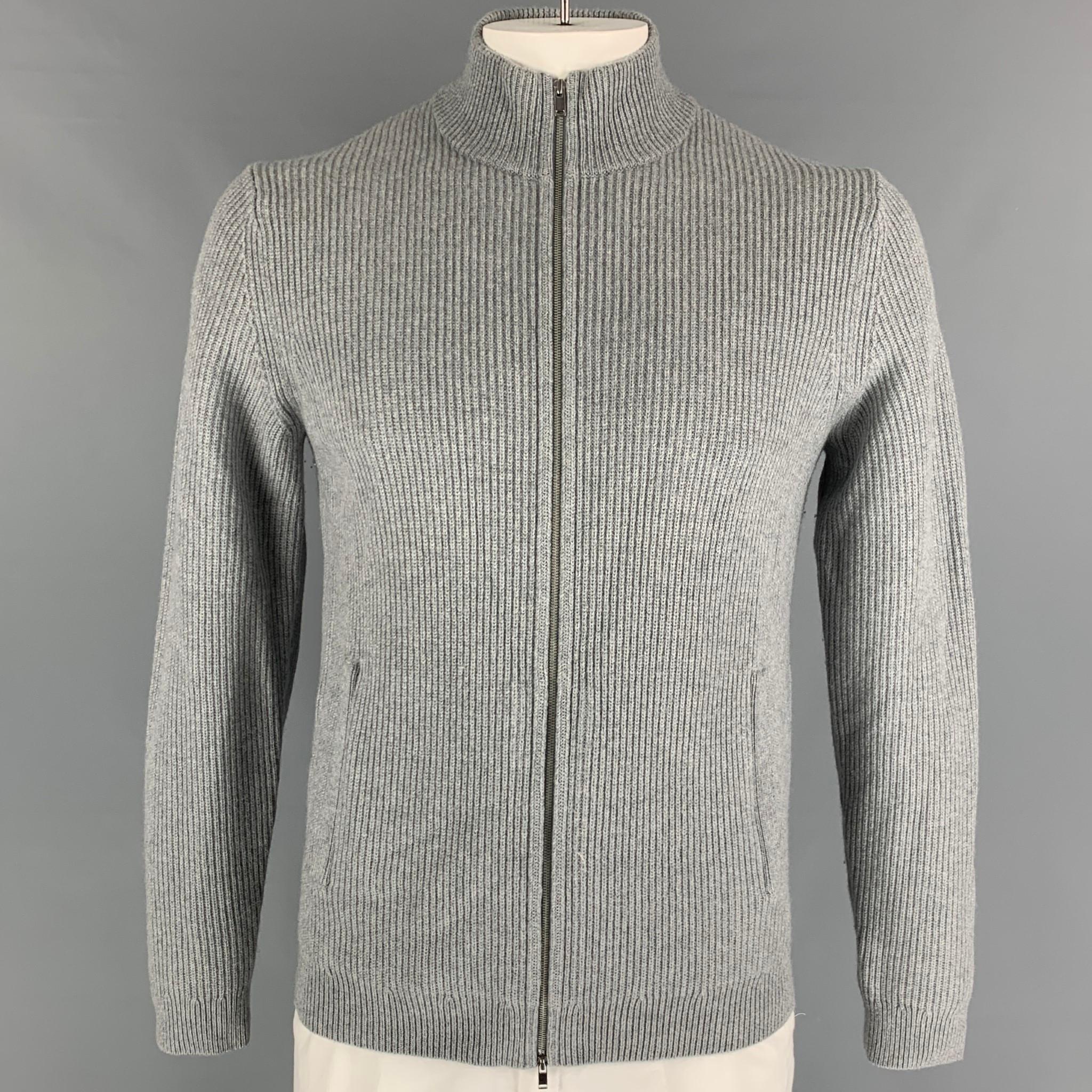 THEORY cardigan comes in a grey ribbed cashmere featuring a high collar, skit pockets, and a zip up closure. 
 
New With Tags.
Marked: L
Original Retail Price: $345.00

Measurements:

Shoulder: 17 in.
Chest: 40 in.
Sleeve: 29.5 in.
Length: 27 in. 