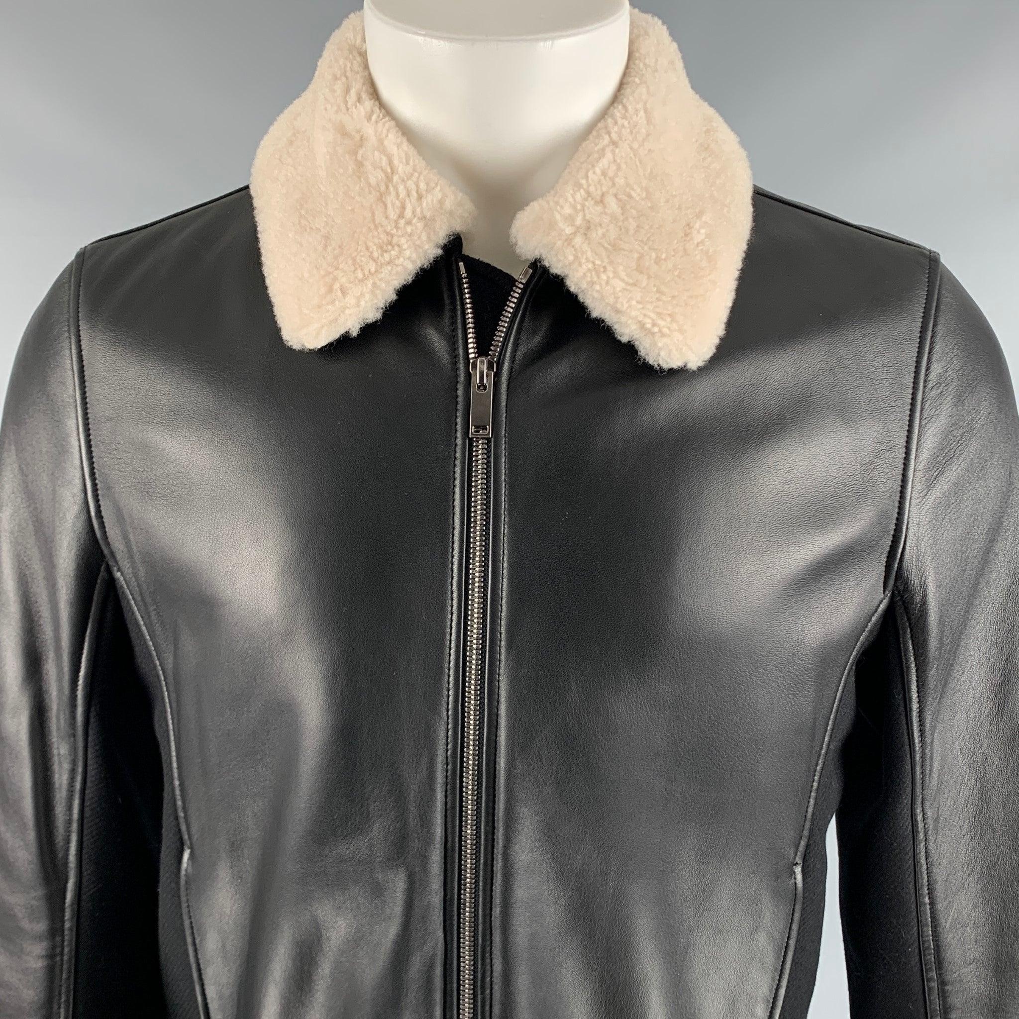 THEORY jacket
in a
black lambskin leather fabric featuring bomber style, detachable shearling collar, two pockets, and a zip up closure.Very Good Pre-Owned Condition. Minor mark on back. 

Marked:   M 

Measurements: 
 
Shoulder: 17 inches Chest: 40