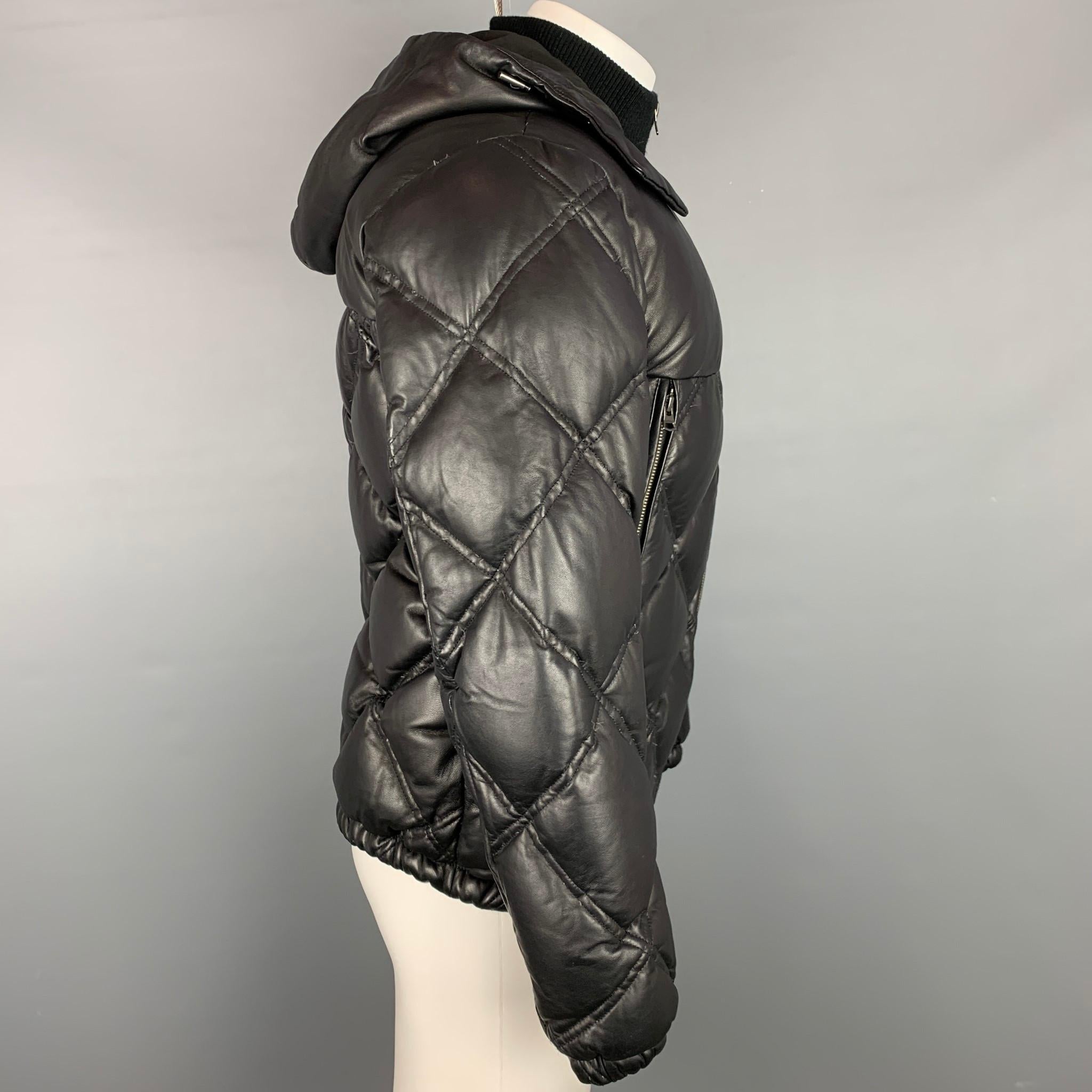 THEORY jacket comes in a black quilted lamb skin leather with a full liner featuring a ribbed collar, hooded style, large zip up pockets. and a full zip up closure. 

Good Pre-Owned Condition.
Marked: M

Measurements:

Shoulder: 18.5 in.
Chest: 42