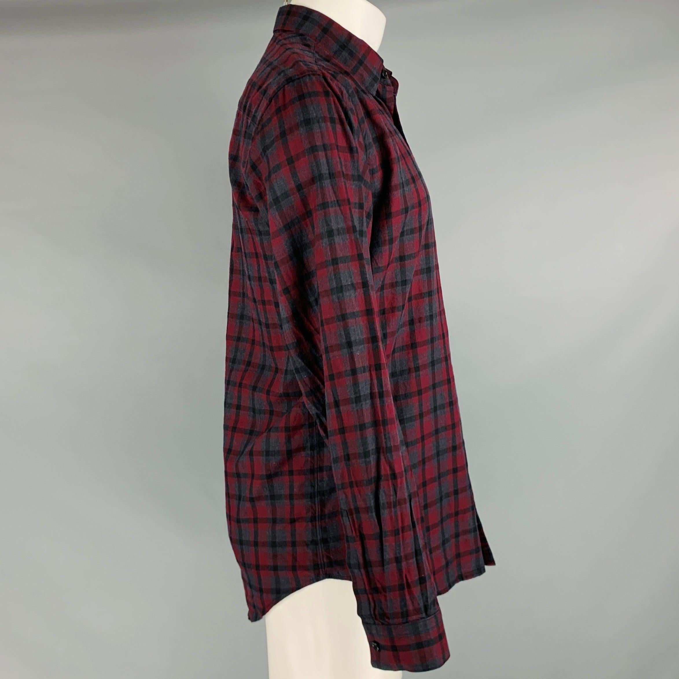 THEORY long sleeve shirt
in a burgundy and charcoal cotton fabric featuring a plaid pattern, spread collar, and button closure.Very Good Pre-Owned Condition. Chipped button. 

Marked:   M 

Measurements: 
 
Shoulder: 18.5 inches Chest: 44 inches