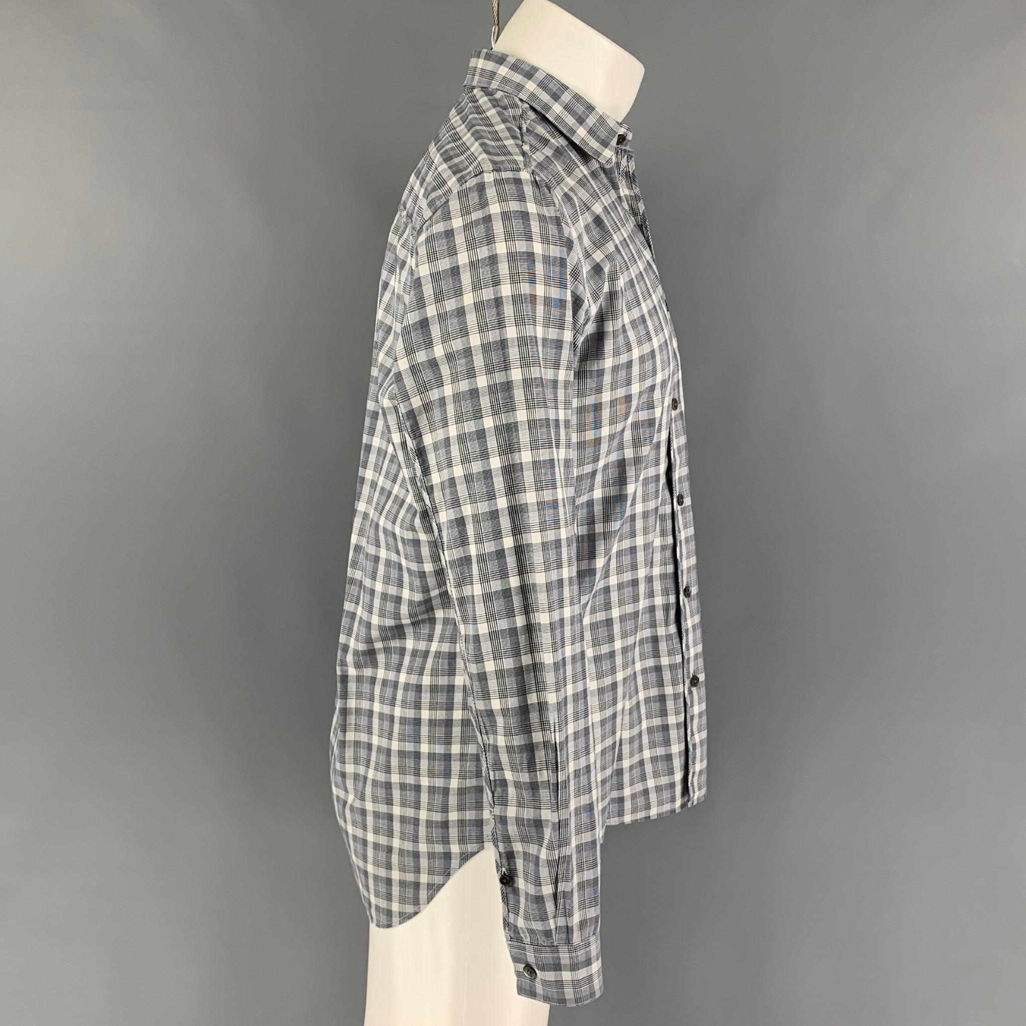 THEORY long sleeve shirt comes in a grey & white plaid cotton featuring a spread collar and a button up closure.
Excellent
Pre-Owned Condition. 

Marked:   M  

Measurements: 
 
Shoulder: 17.5 inches Chest: 44 inches Sleeve: 25 inches Length: 29.5