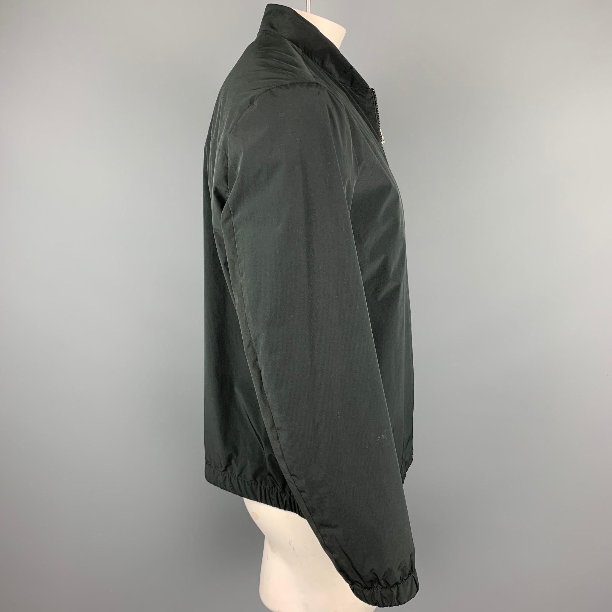 THEORY jacket comes in a black polyester / nylon featuring a ribbed collar, slit pockets, and a full zip closure. Minor wear throughout. As-Is.

Good Pre-Owned Condition.
Marked: XL

Measurements:

Shoulder: 19 in. 
Chest: 48 in. 
Sleeve: 26 in.