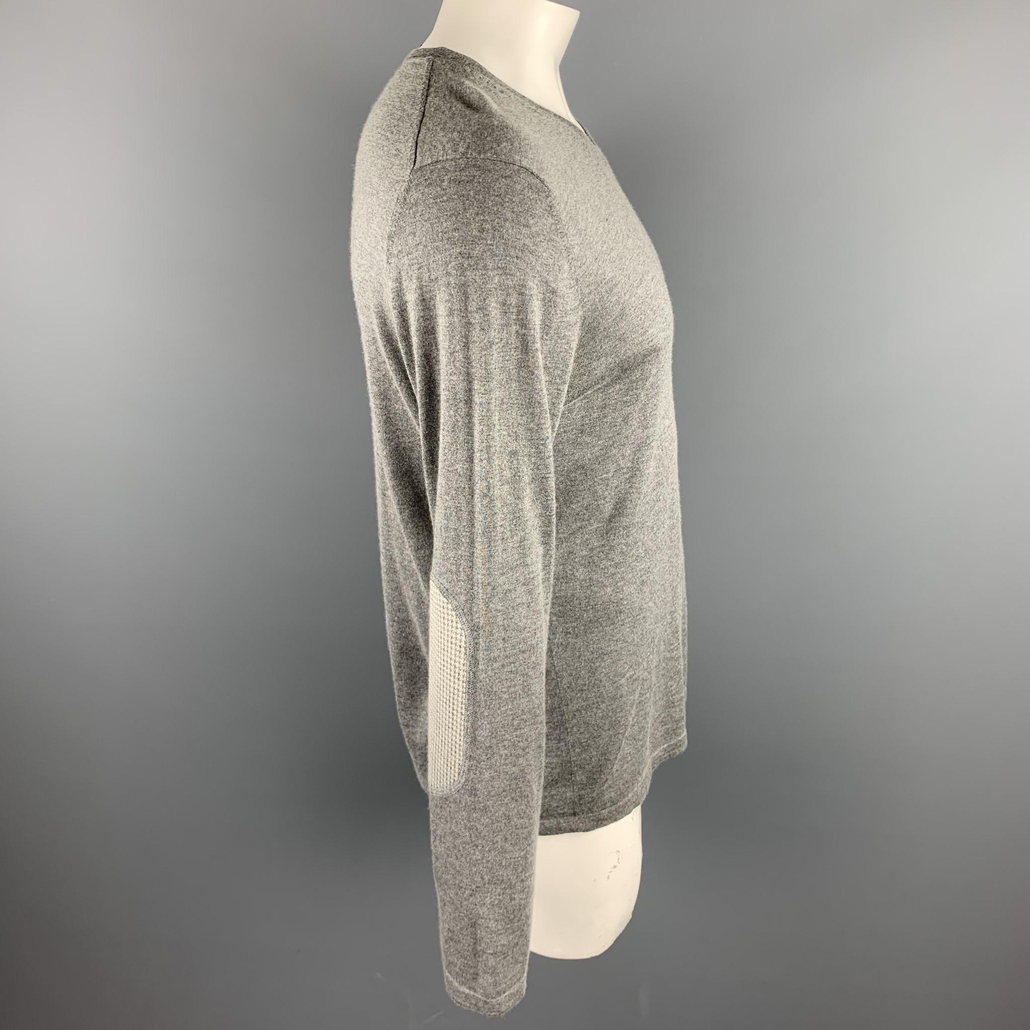 THEORY pullover comes in a gray silk / cashmere featuring elbow patch details and a v-neck. Minor wear. As-Is.

Excellent Pre-Owned Condition.
Marked: XL

Measurements:

Shoulder: 18 in. 
Chest: 42 in. 
Sleeve: 27 in. 
Length: 28 in. 
