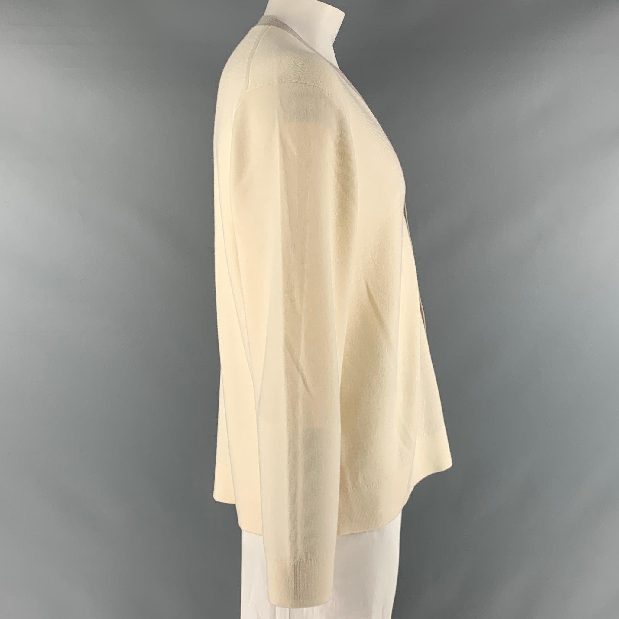THEORY cardigan comes in a cream and taupe merino wool blend knit material featuring V-neck, and a buttoned closure. Excellent Pre-Owned Condition. 

Marked:   XXL 

Measurements: 
 
Shoulder: 21 inches Chest: 52 inches Sleeve: 26.5 inches Length: