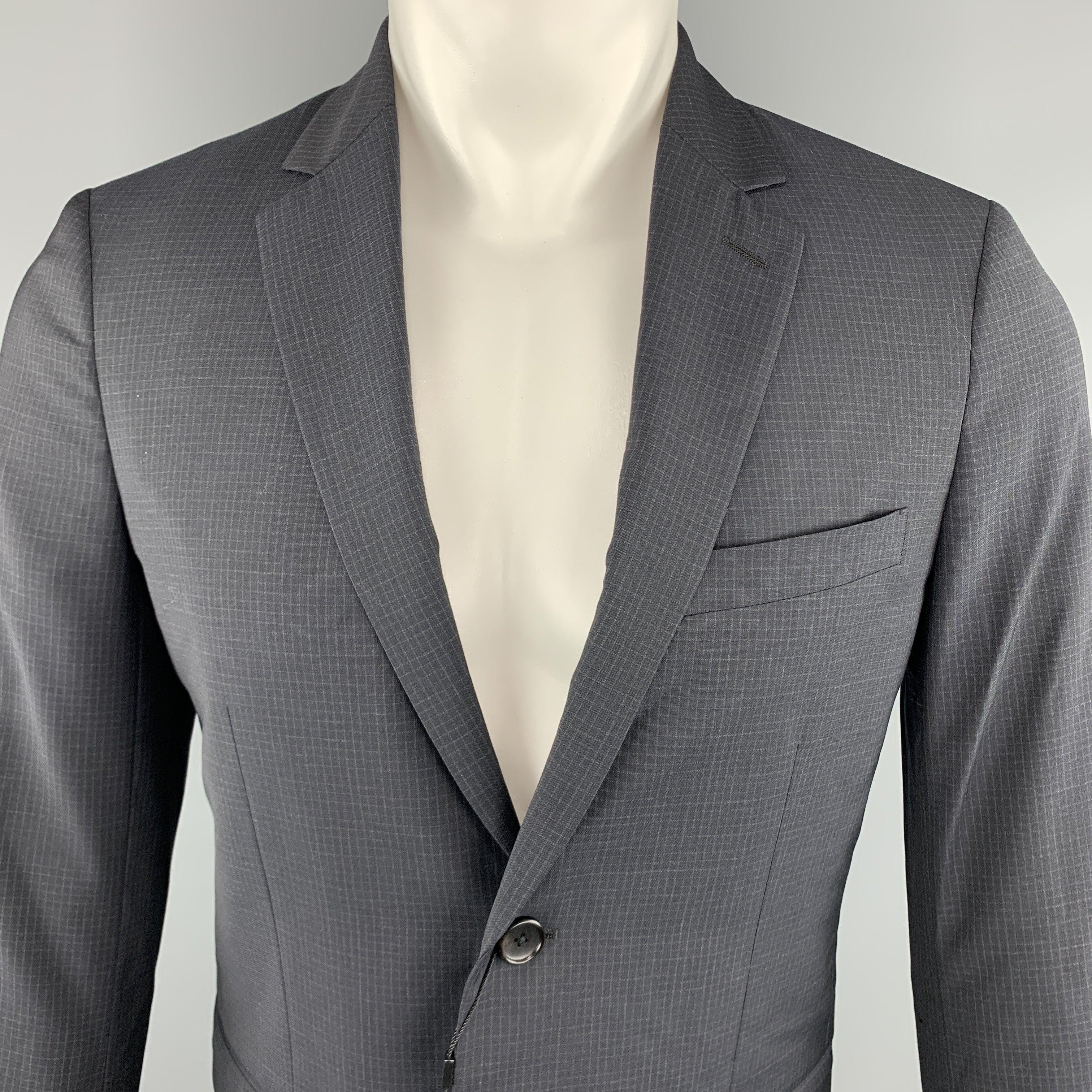 THEORY Wellar Sport Coat
comes in a navy tone in a grid wool material, with a notch lapel, slit and flap pockets, two buttons at closure, single breasted, buttoned cuffs and a single vent at back.New With Tags. 

Marked:   38R 

Measurements: 
