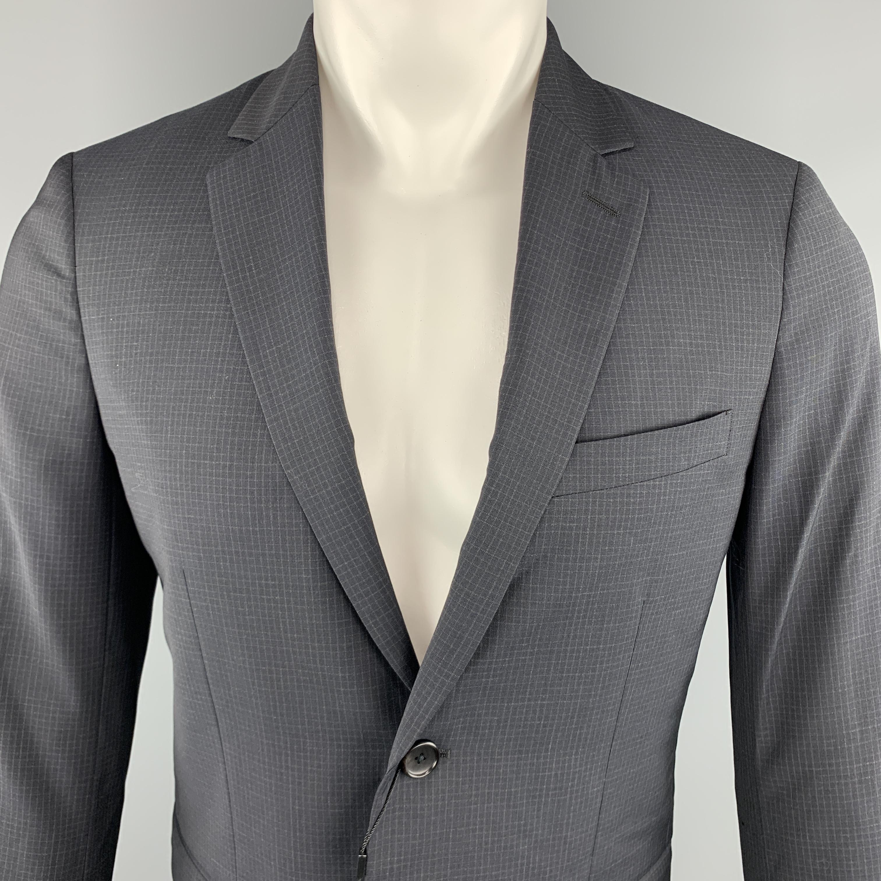 THEORY Wellar Sport Coat comes in a navy tone in a grid wool material, with a notch lapel, slit and flap pockets, two buttons at closure, single breasted, buttoned cuffs and a single vent at back.

New With Tags.
Marked:
